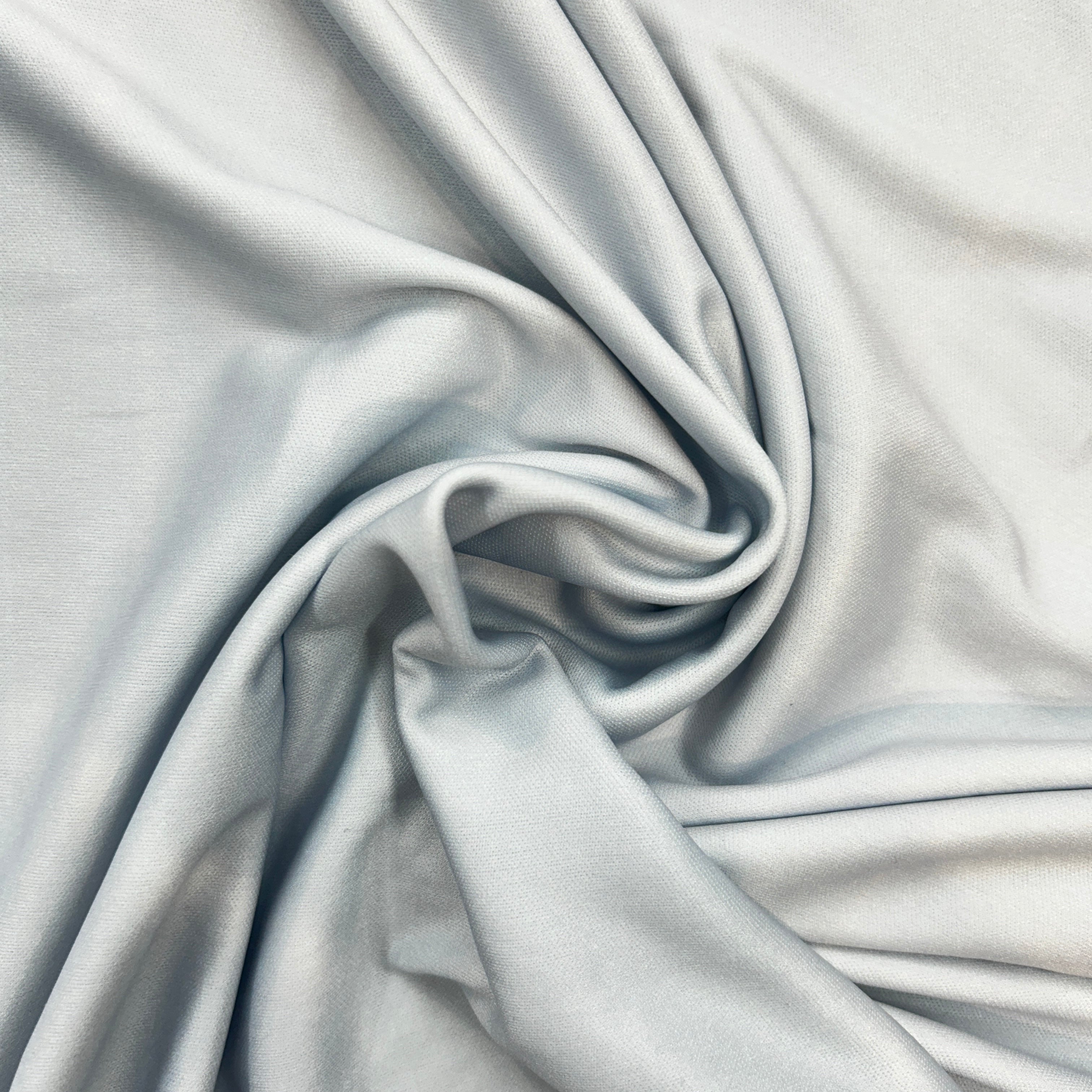 Close-up of light gray fabric with folds