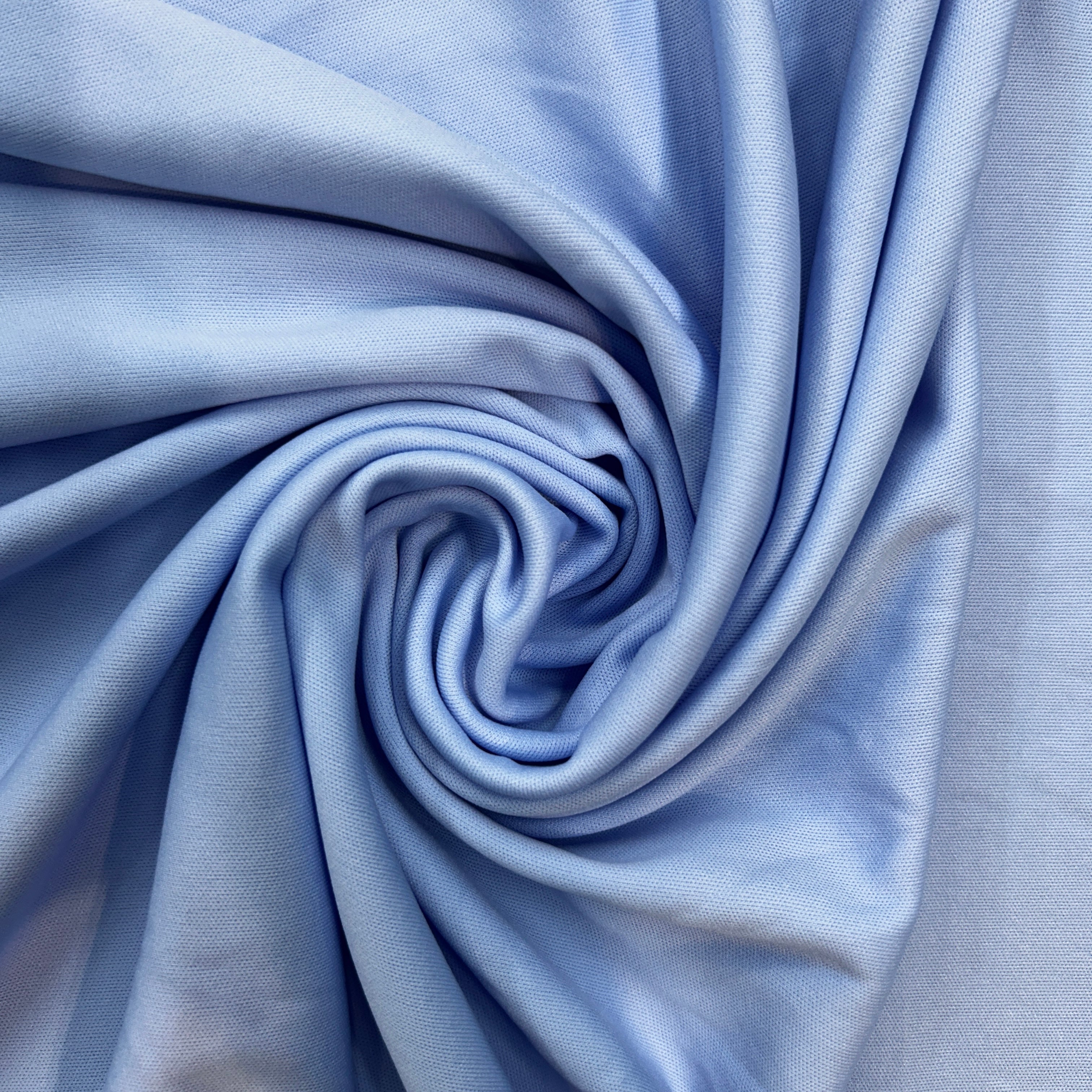 Close-up of blue fabric with a swirl pattern