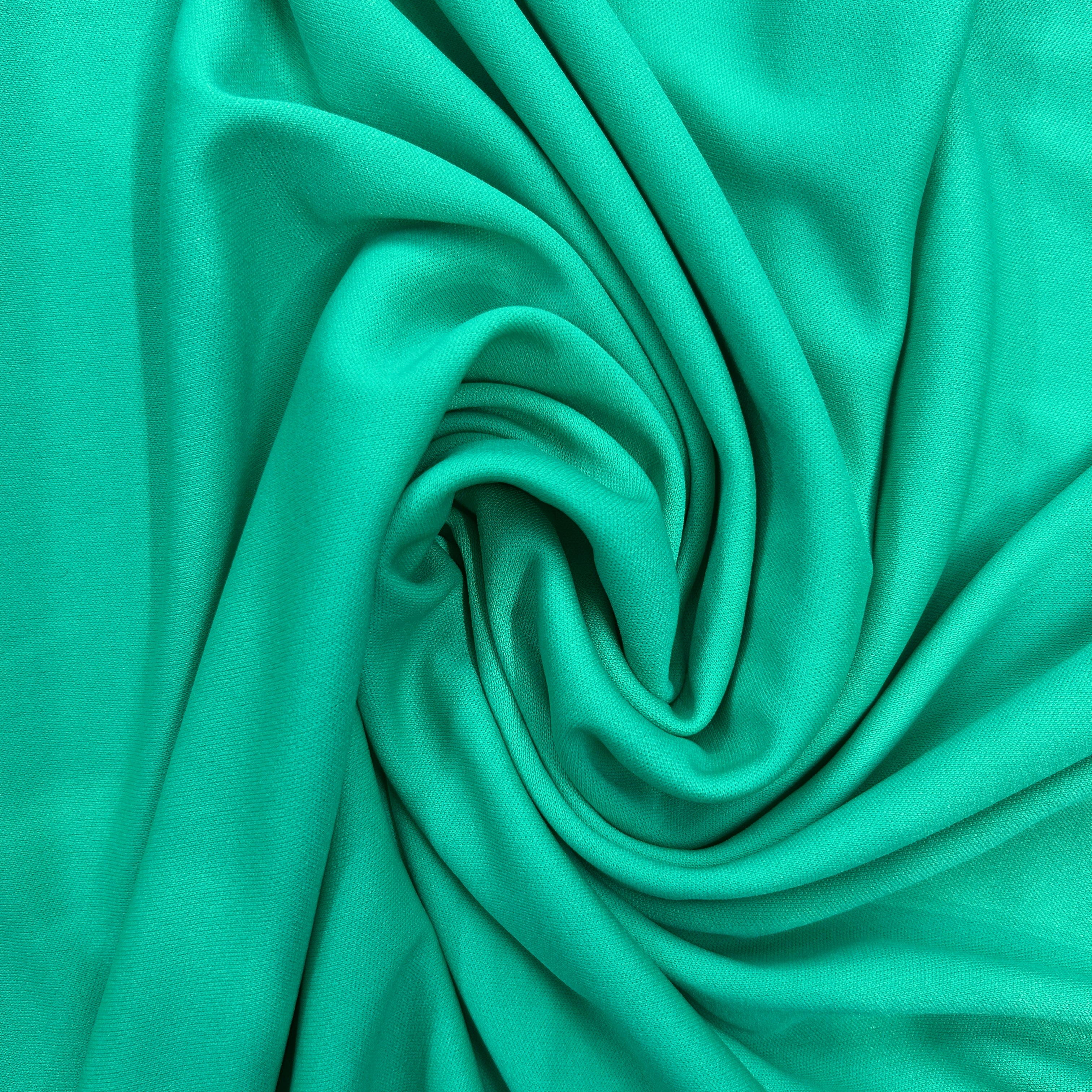 Close-up of teal fabric with a swirl pattern