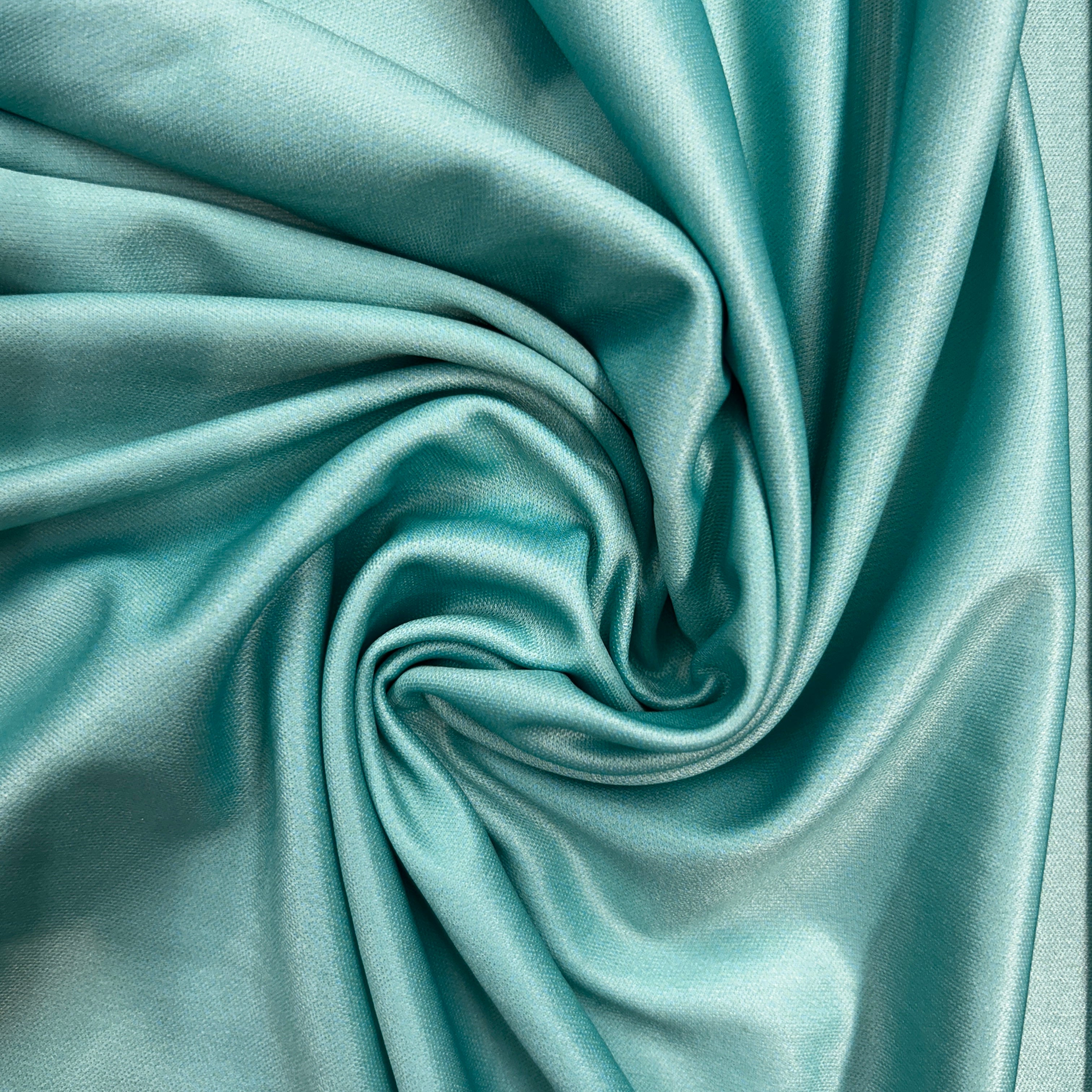 Close-up of teal fabric with folds