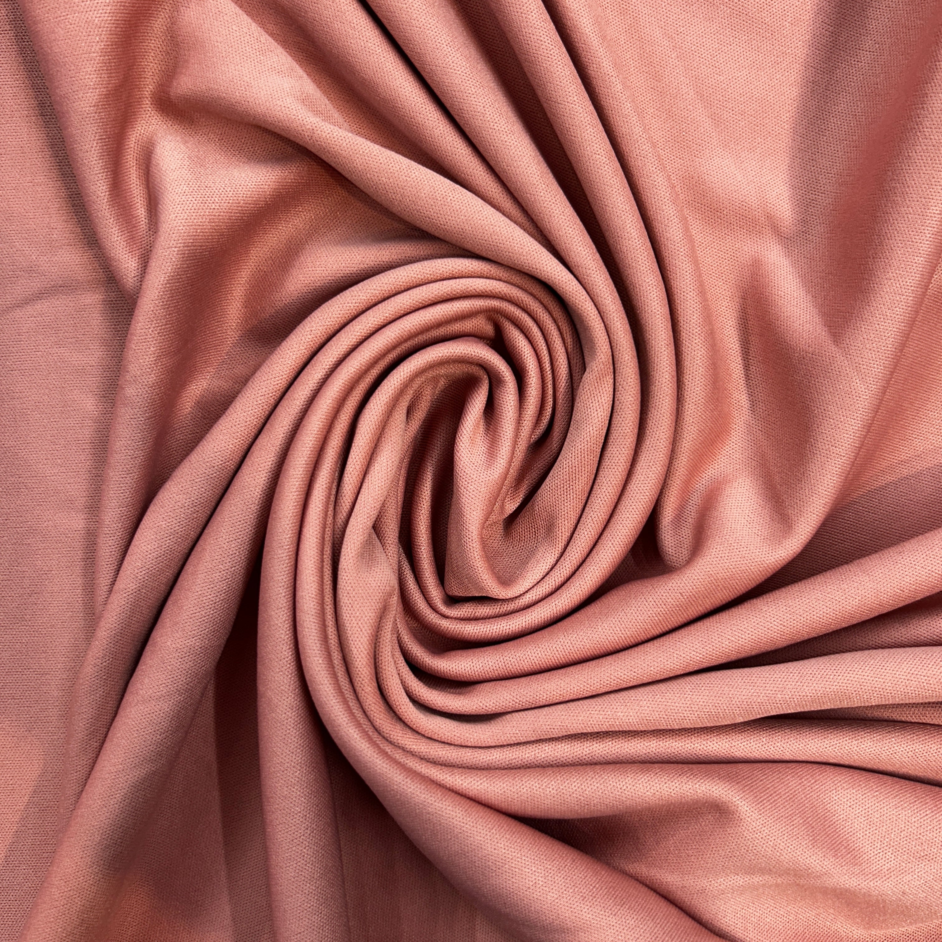 Close-up of pink fabric with a swirl pattern