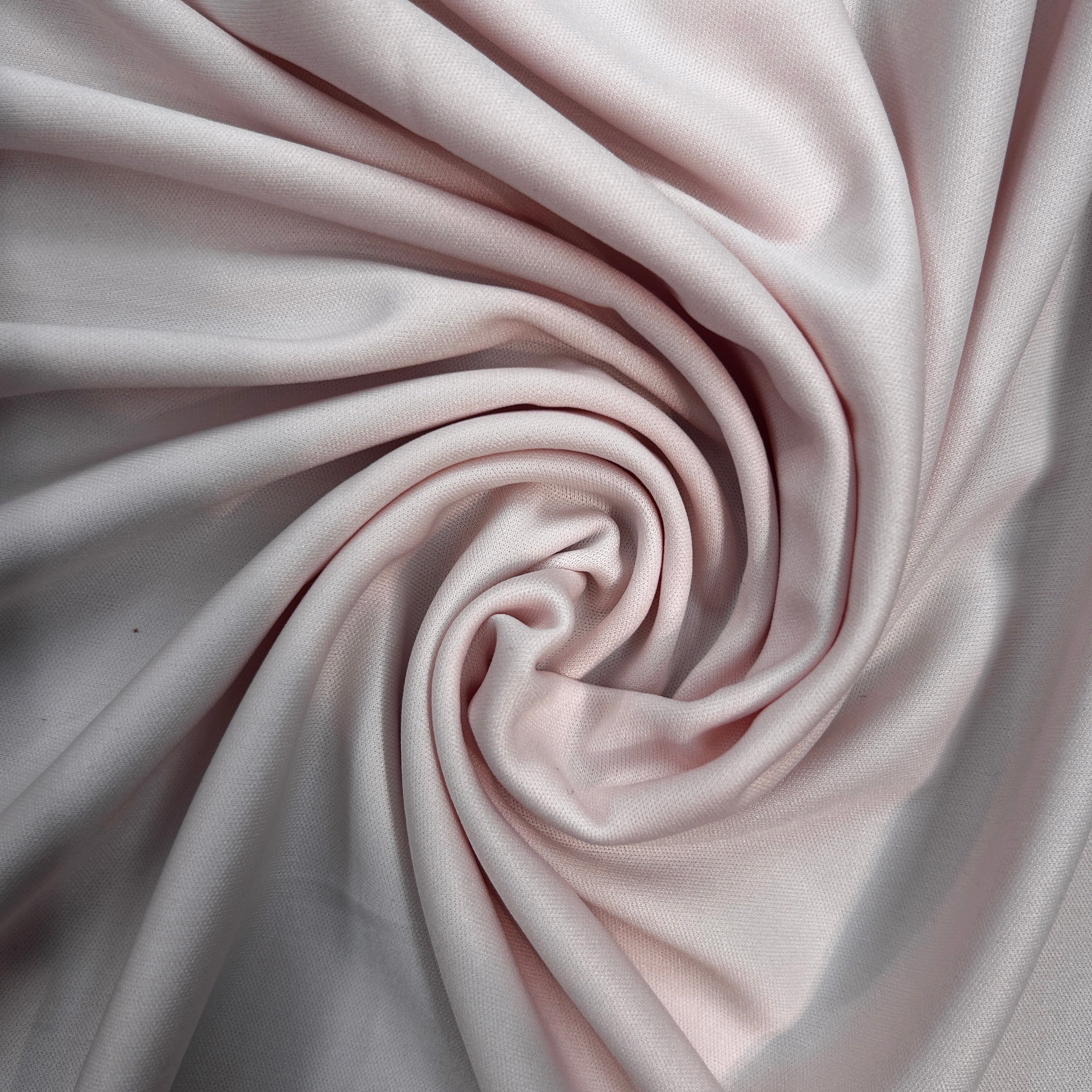 Close-up of pink fabric with a swirl pattern