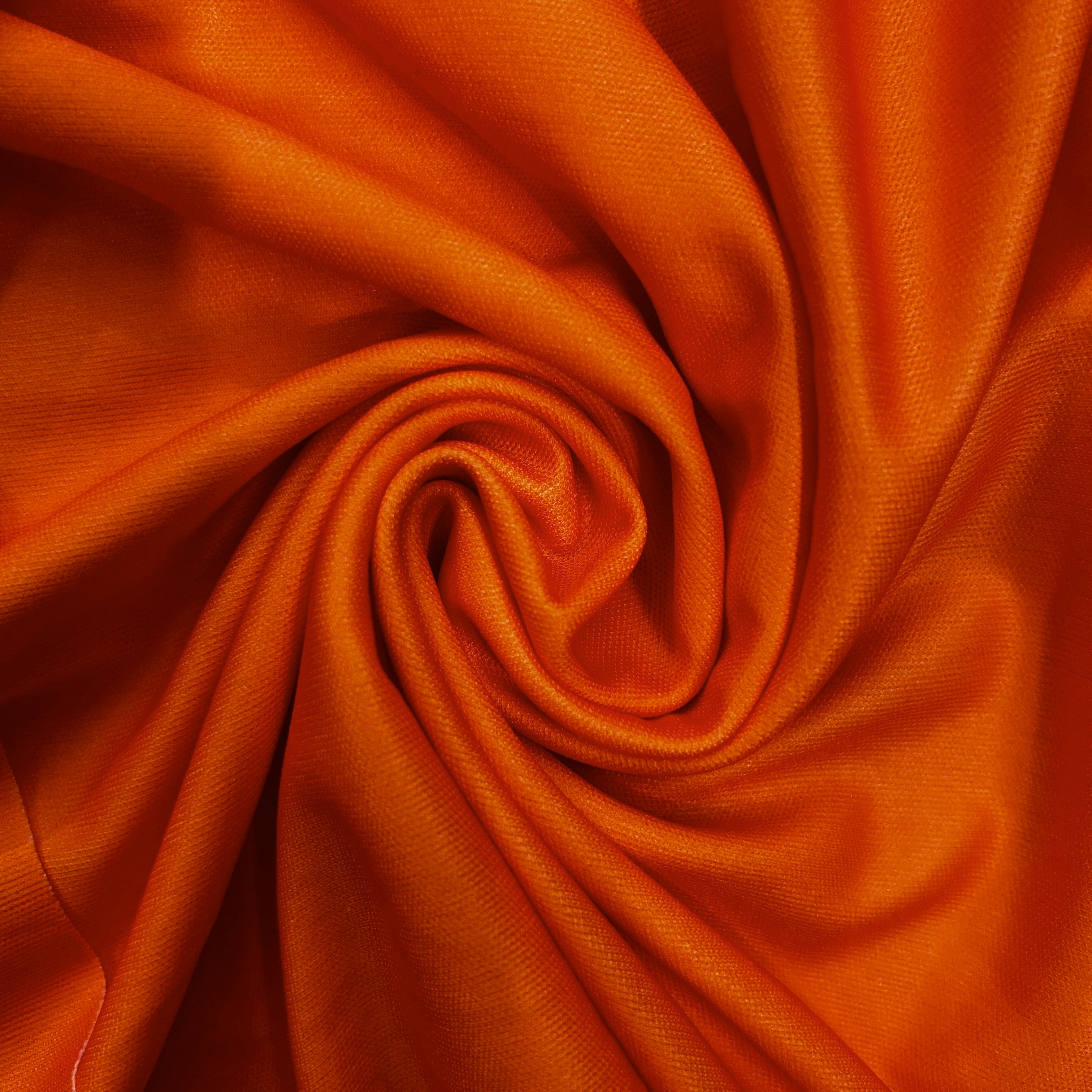 Close-up of orange fabric with folds