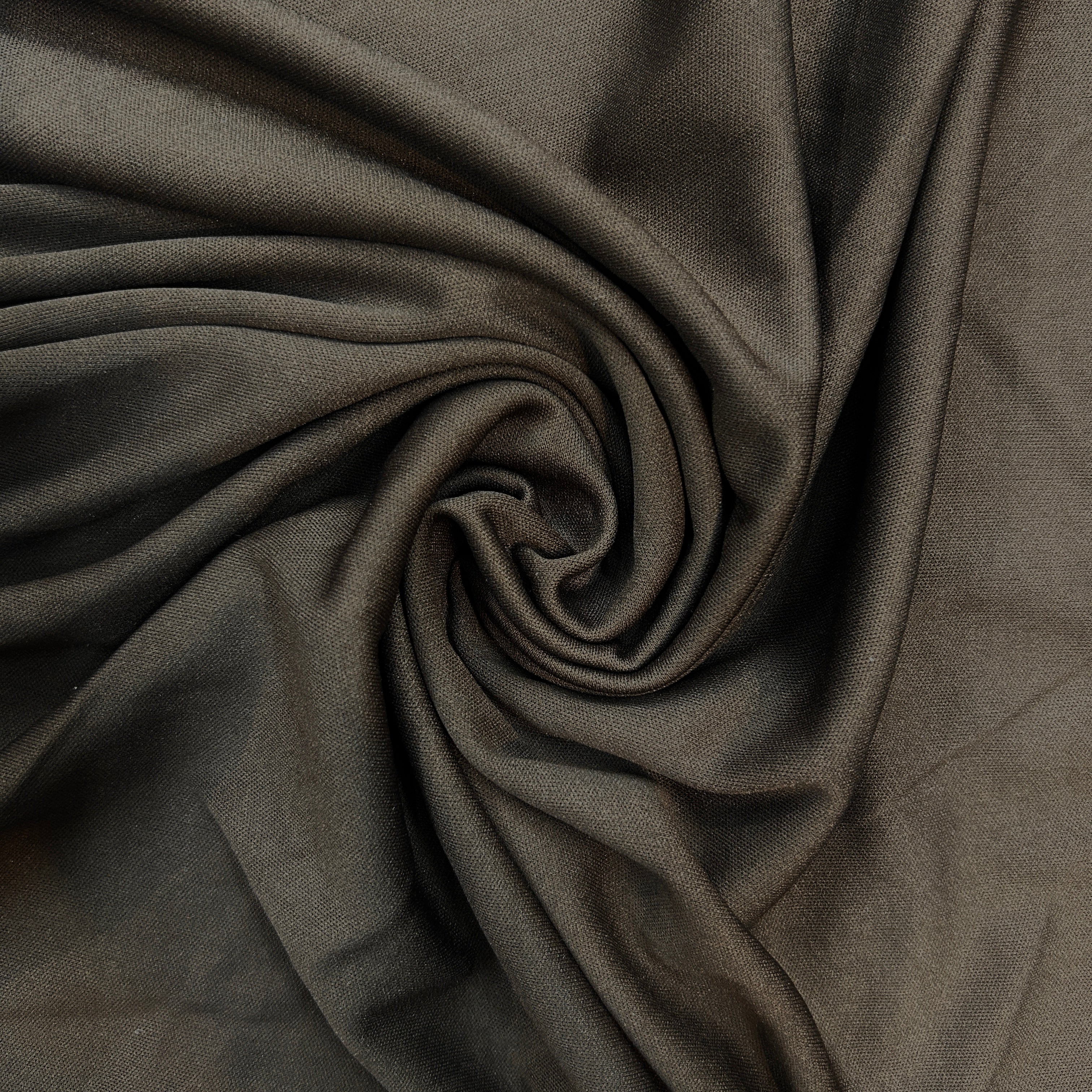 Close-up of dark brown fabric with folds