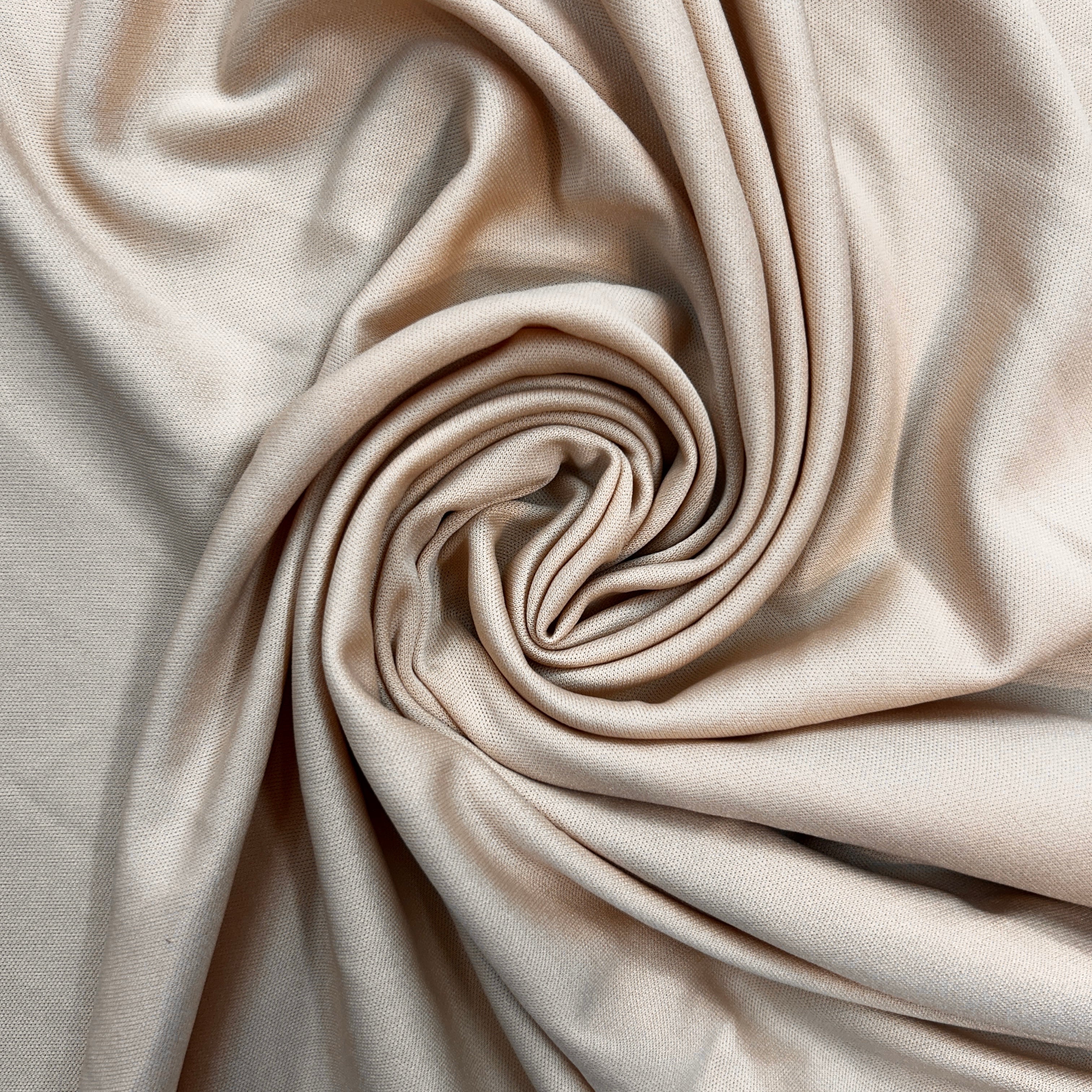 Close-up of beige fabric with folds