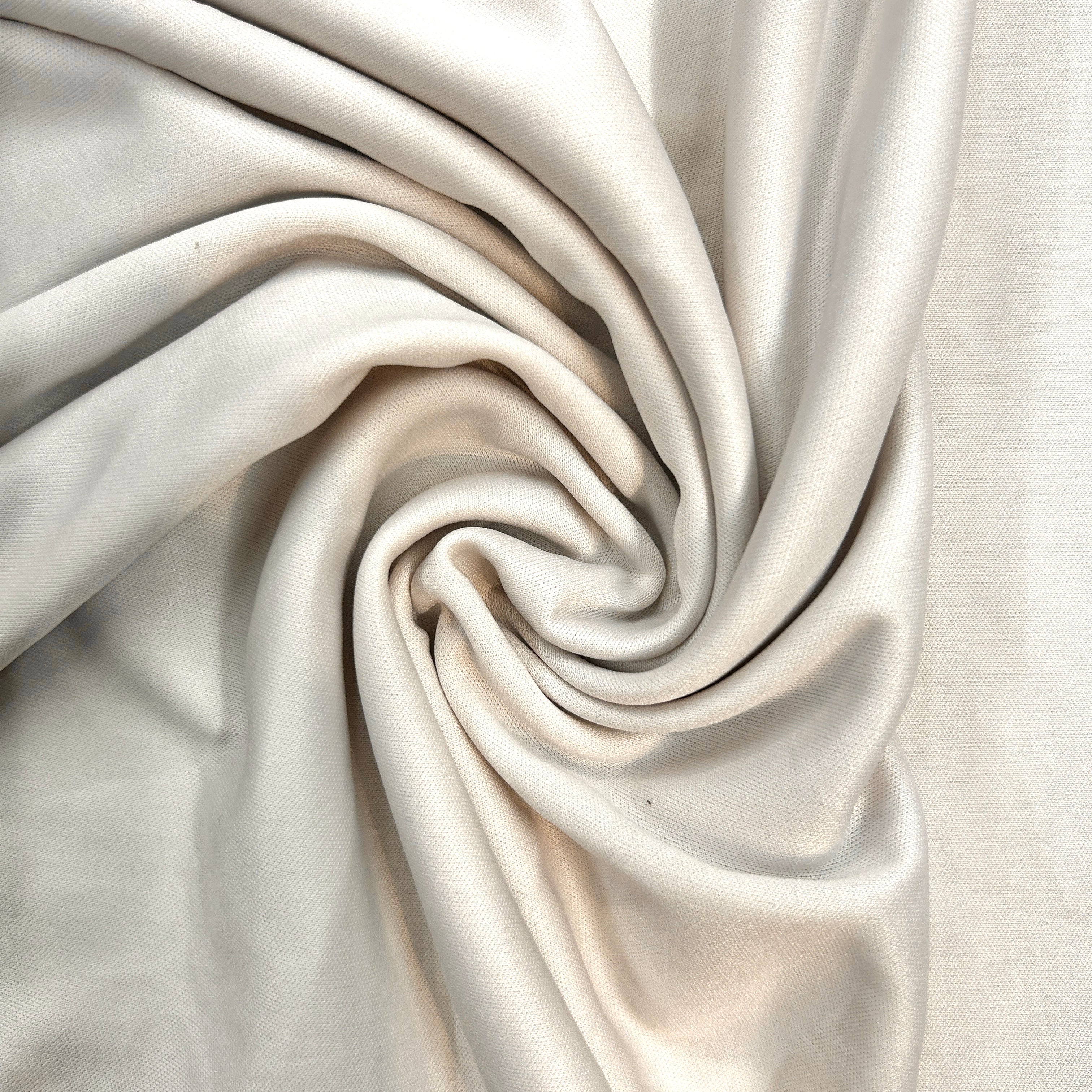 Close-up of beige fabric with folds