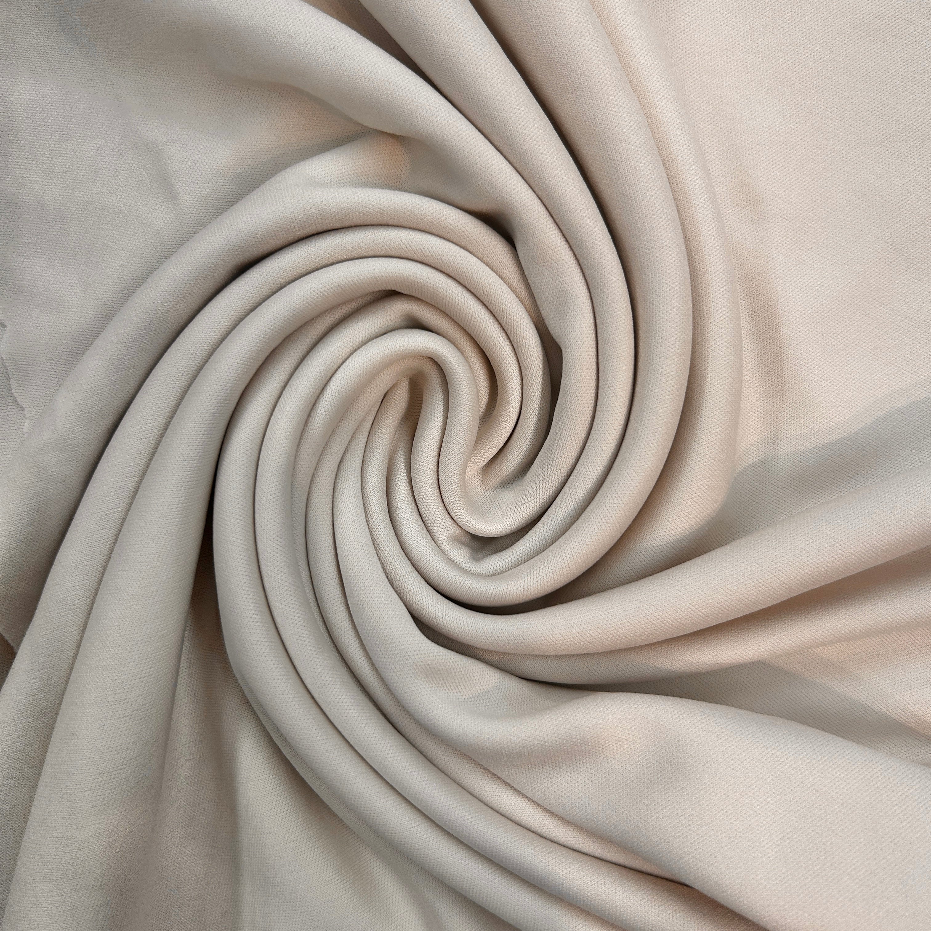 Close-up of beige fabric with a spiral pattern