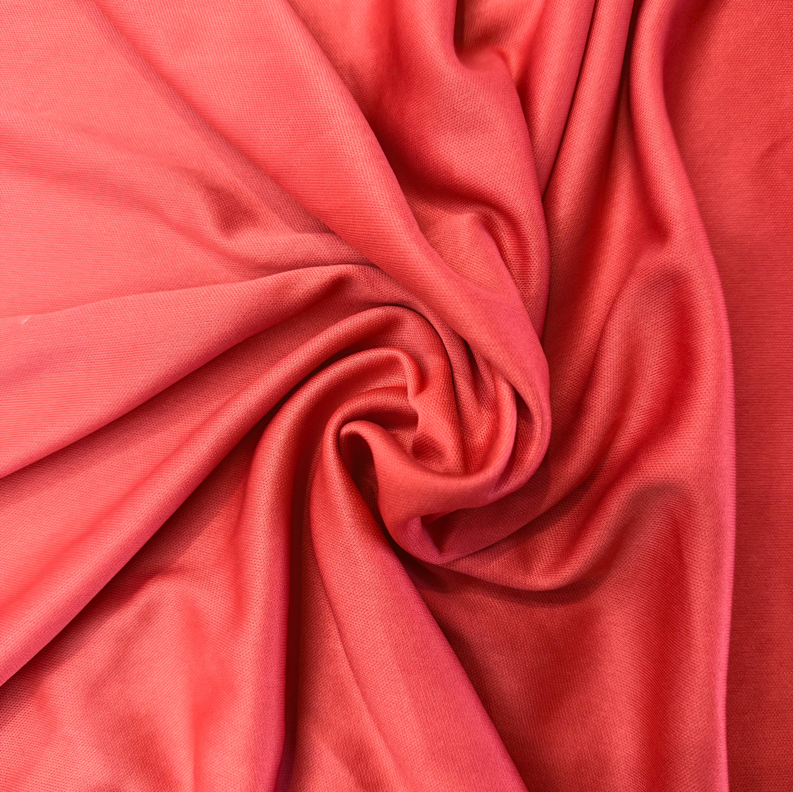 Close-up of pinkish-red fabric with folds