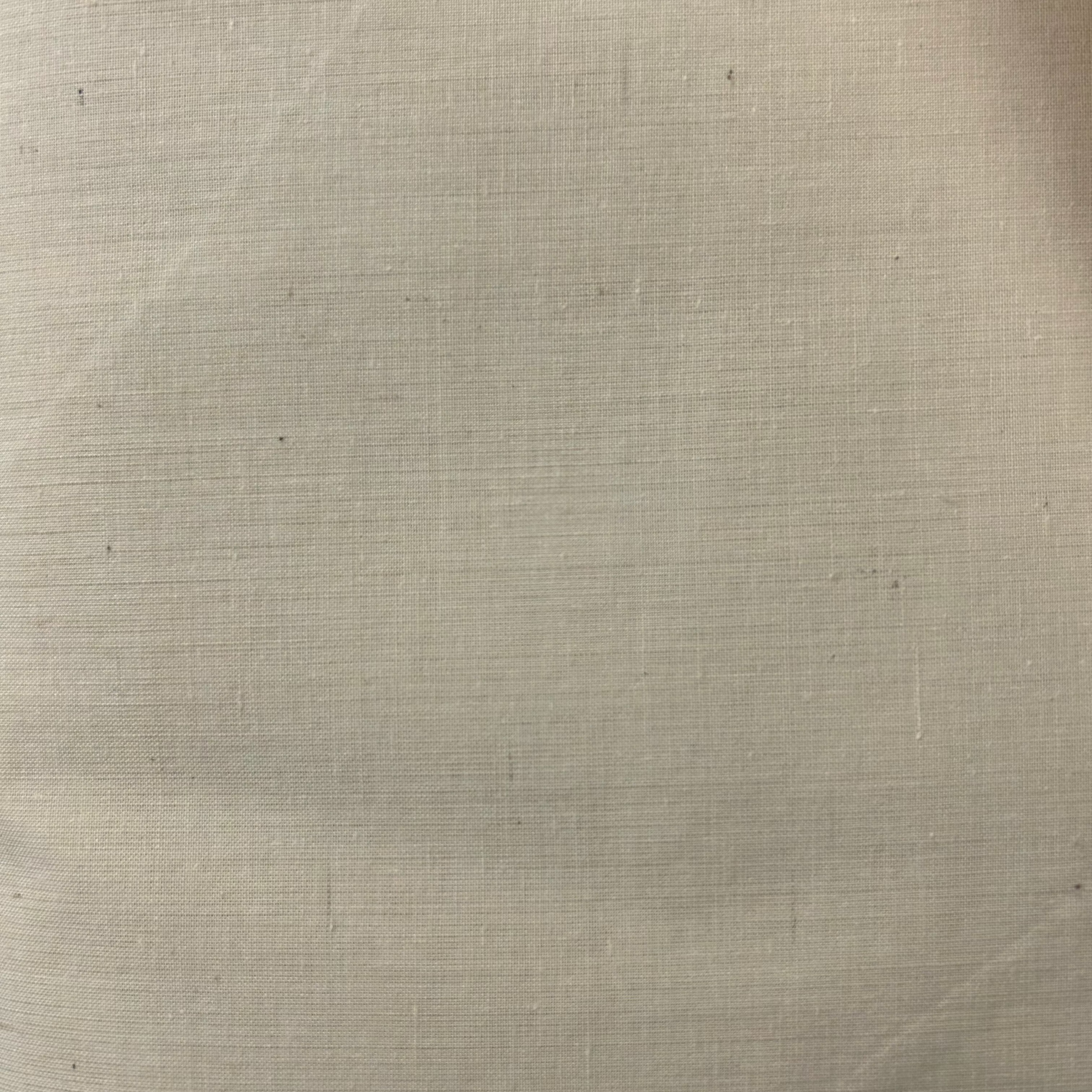A plain-woven cotton calico fabric in a nude color with a slightly textured surface.