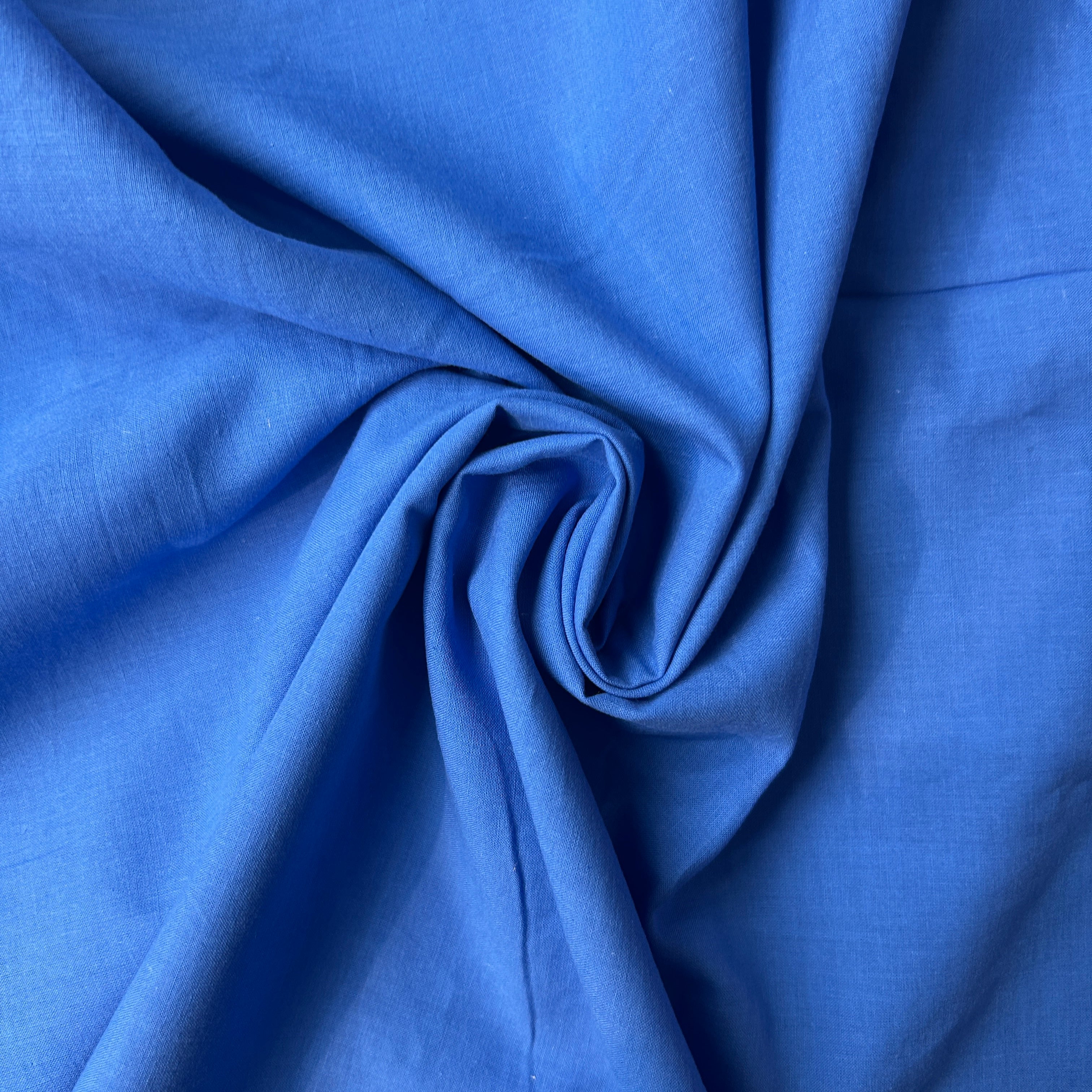 Close-up of blue fabric with folds