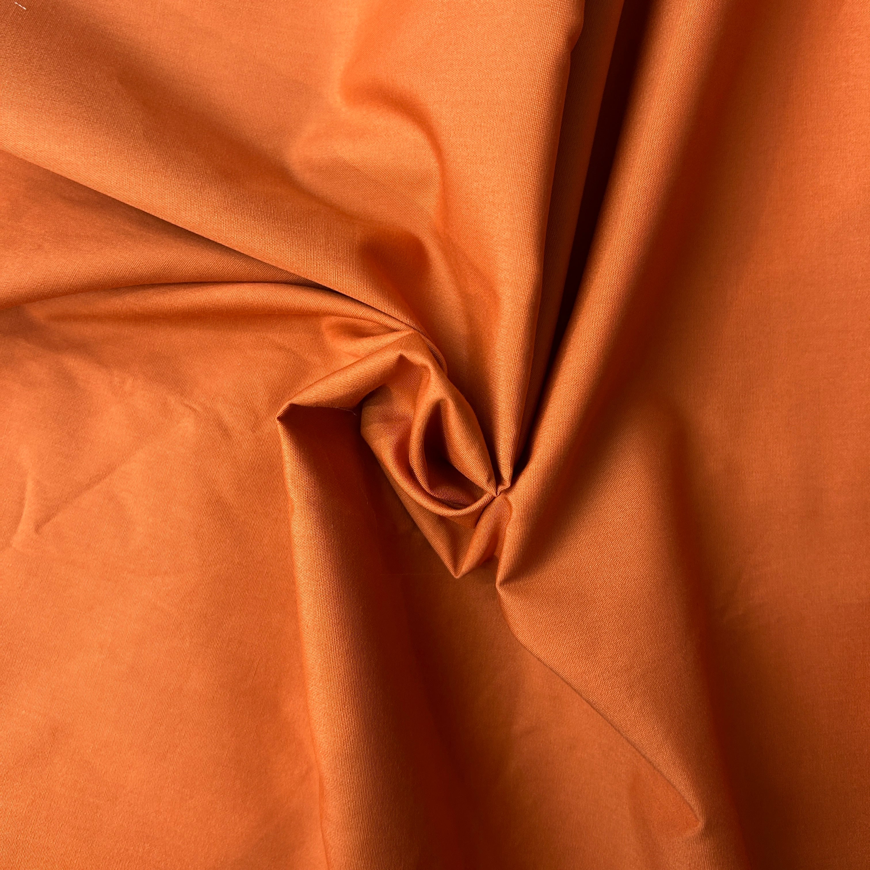Close-up of orange fabric with folds