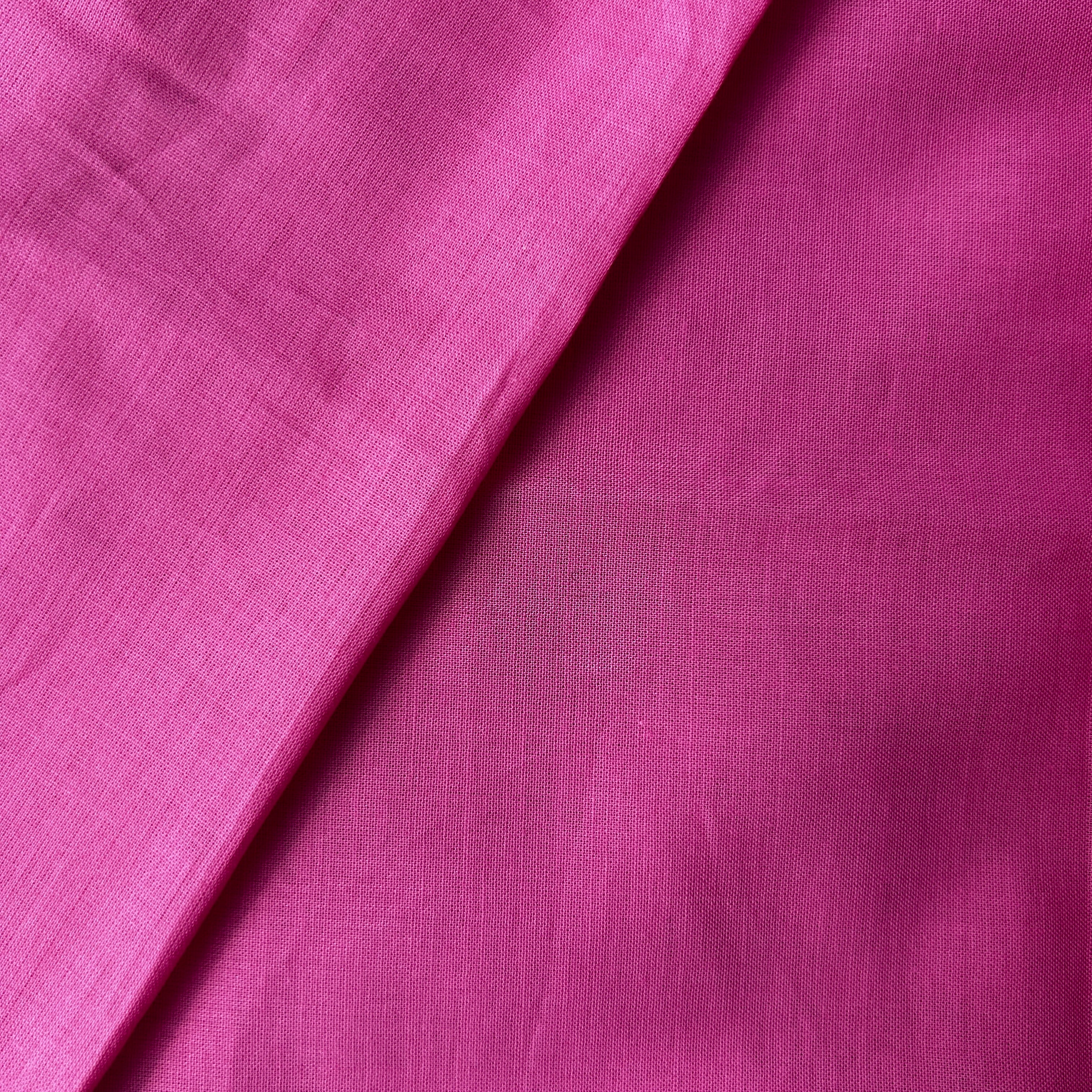 Close-up of pink fabric with a subtle texture