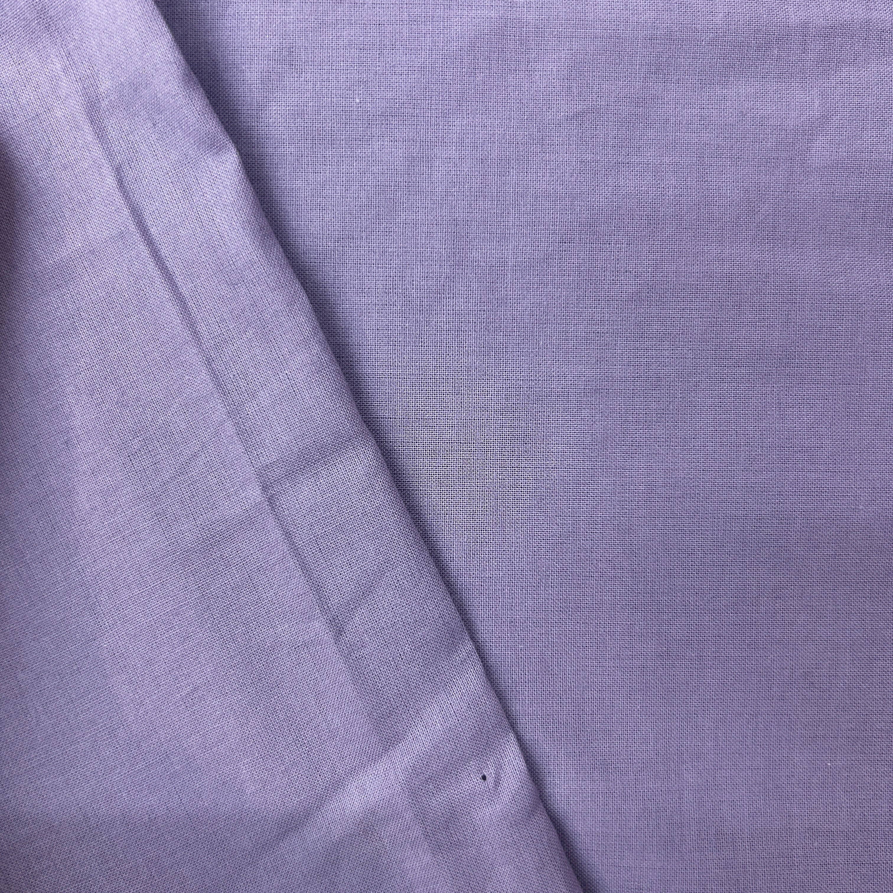 Close-up of purple fabric with a subtle pattern