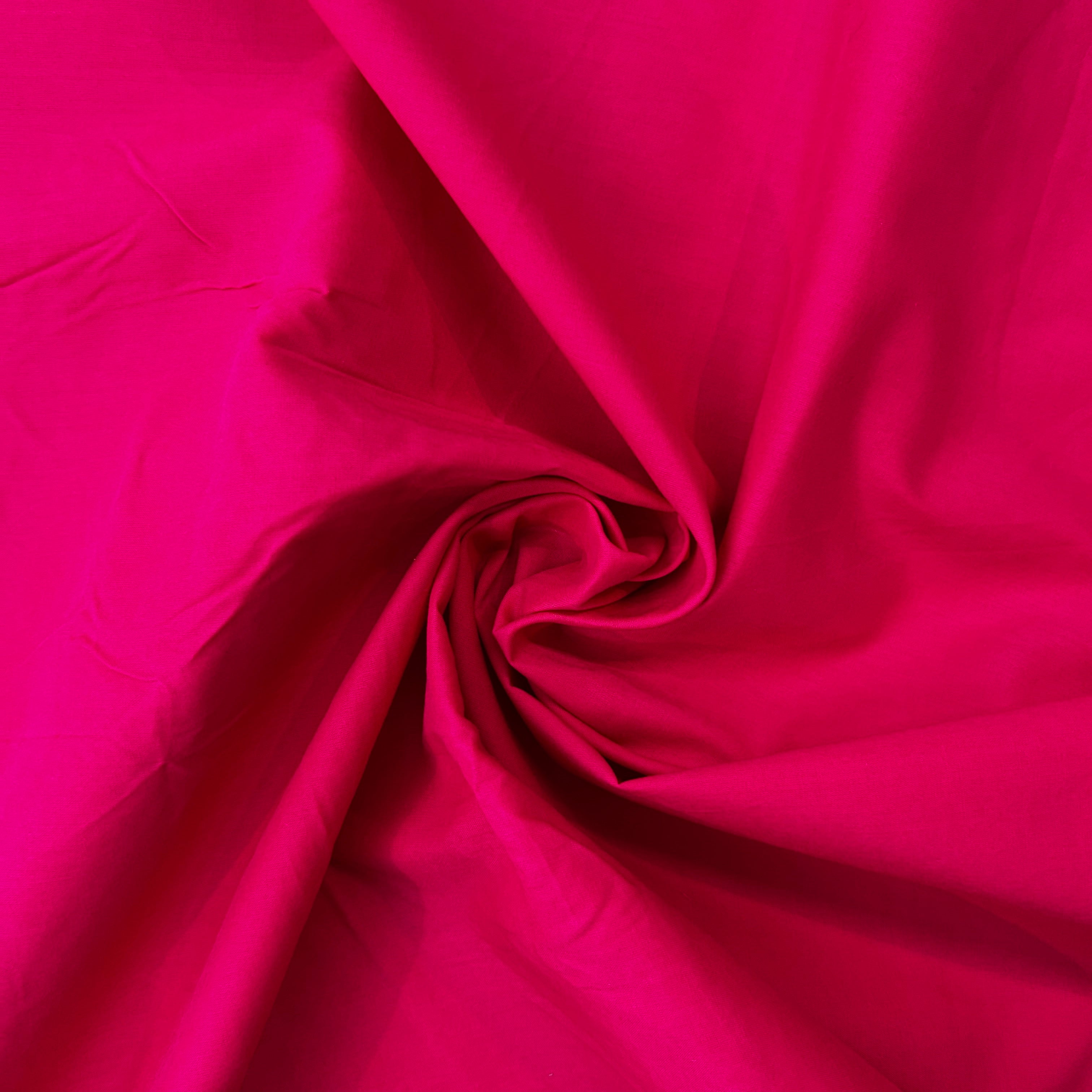 Close-up of pink fabric with a visible crease