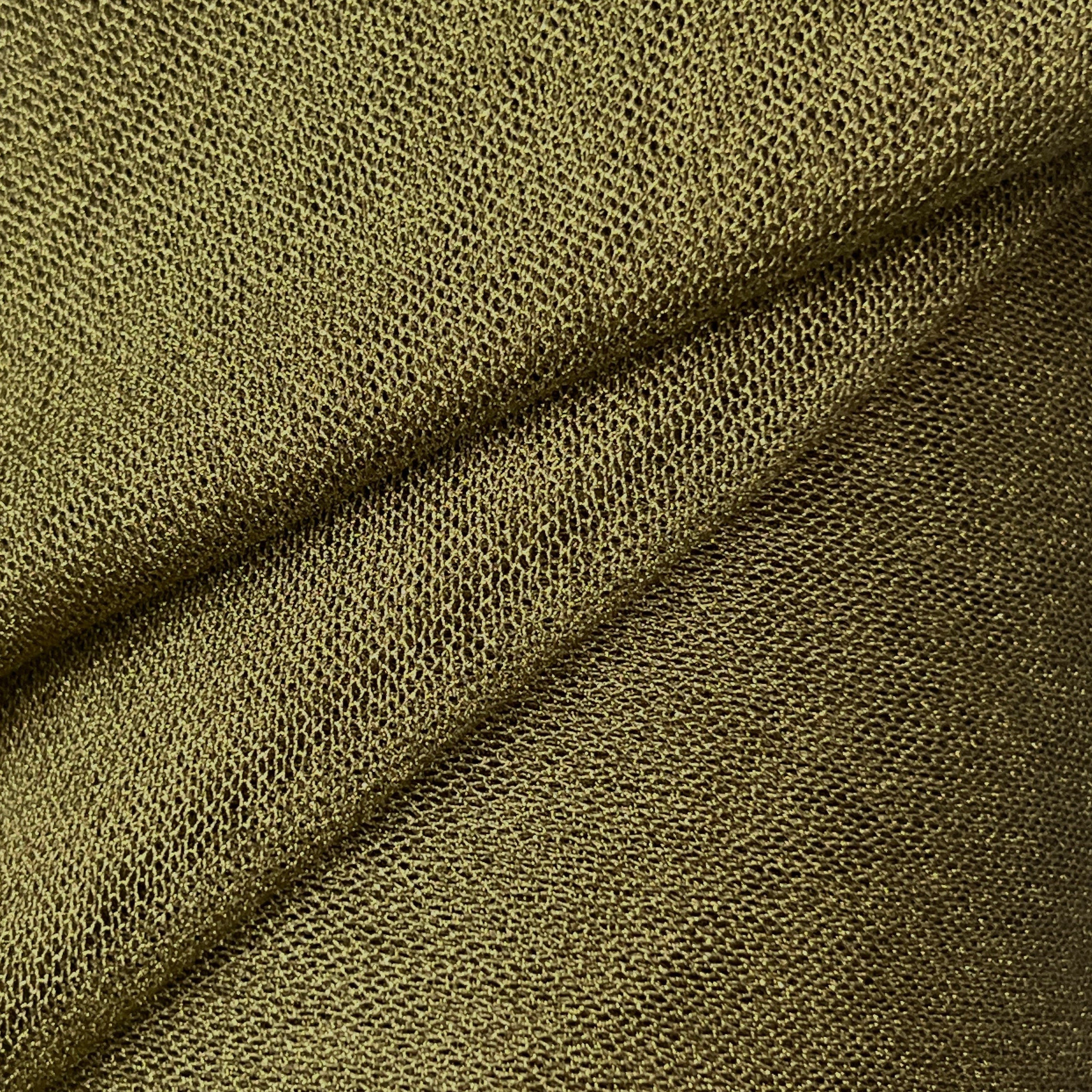 Close-up of textured green fabric with a diagonal fold