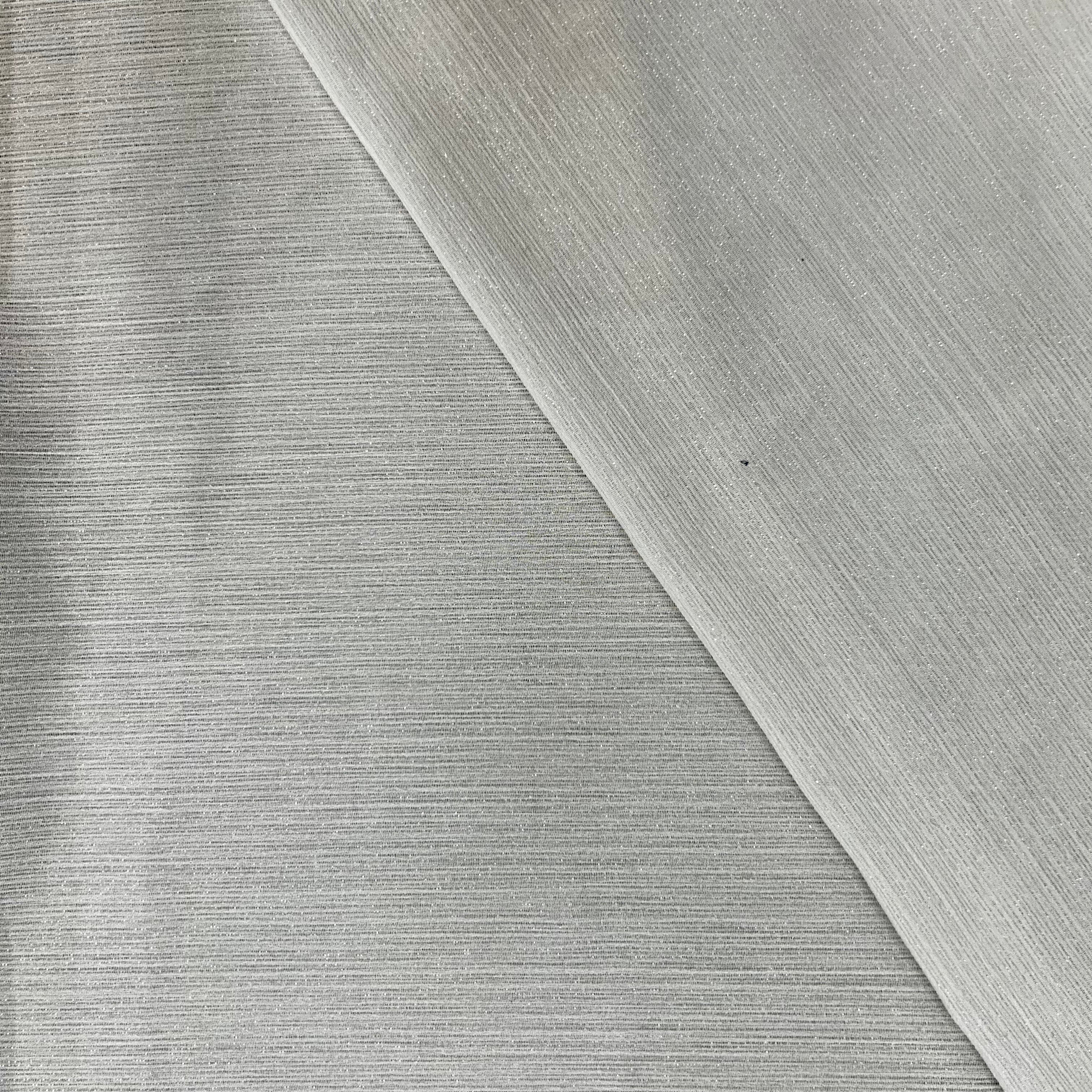 Close-up of textured white paper with a diagonal crease.