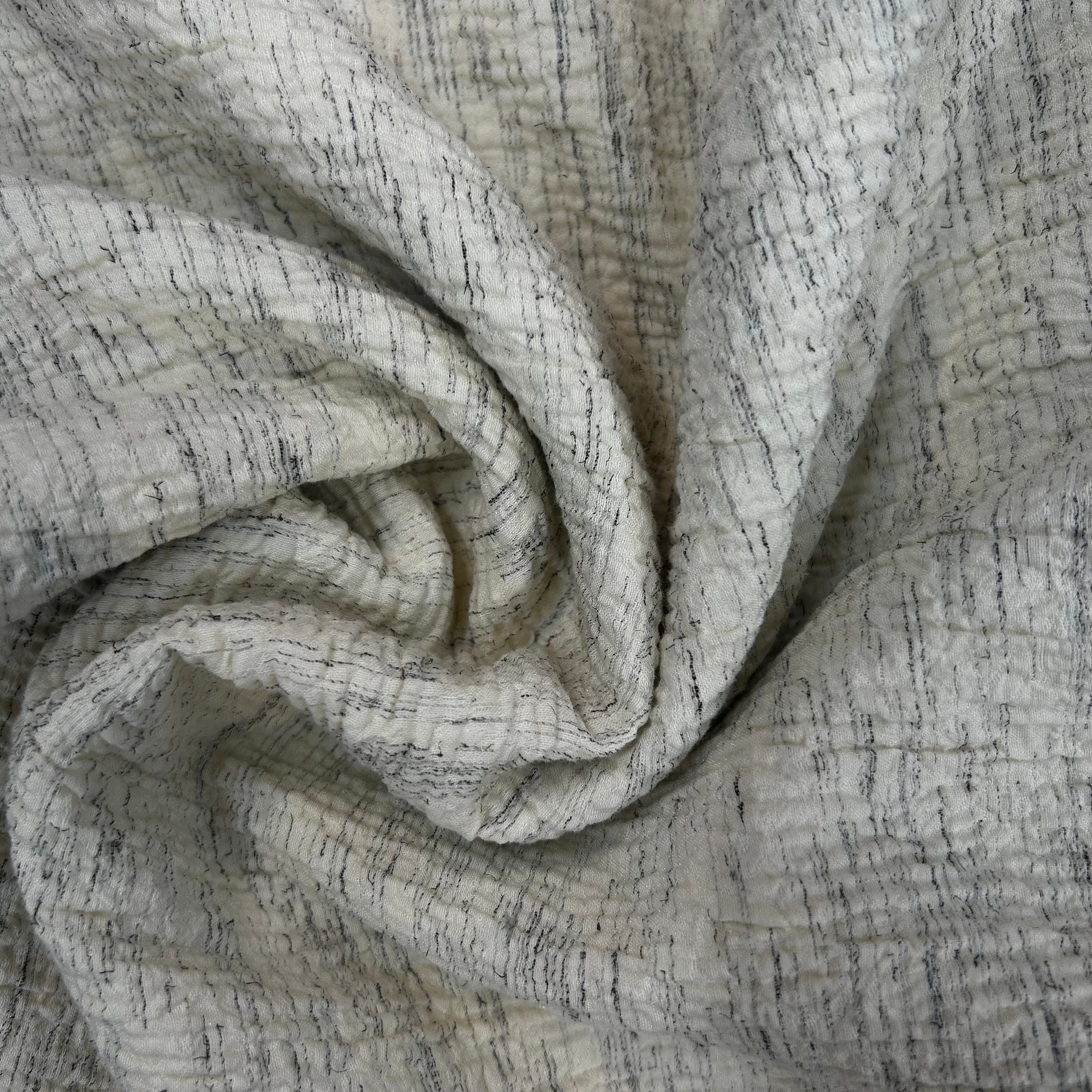 Close-up of textured fabric with a neutral color palette