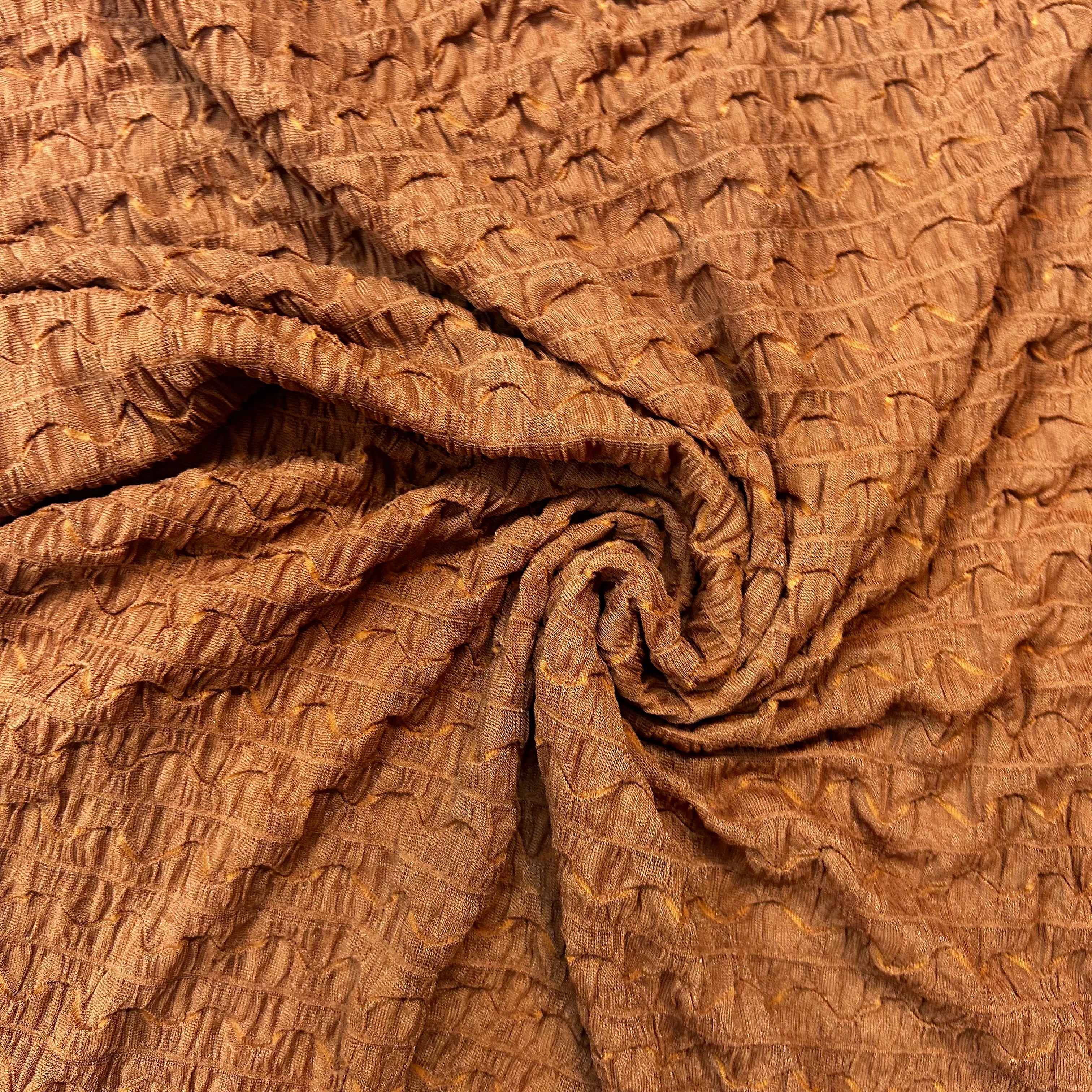 Brown textured fabric with a crumpled appearance