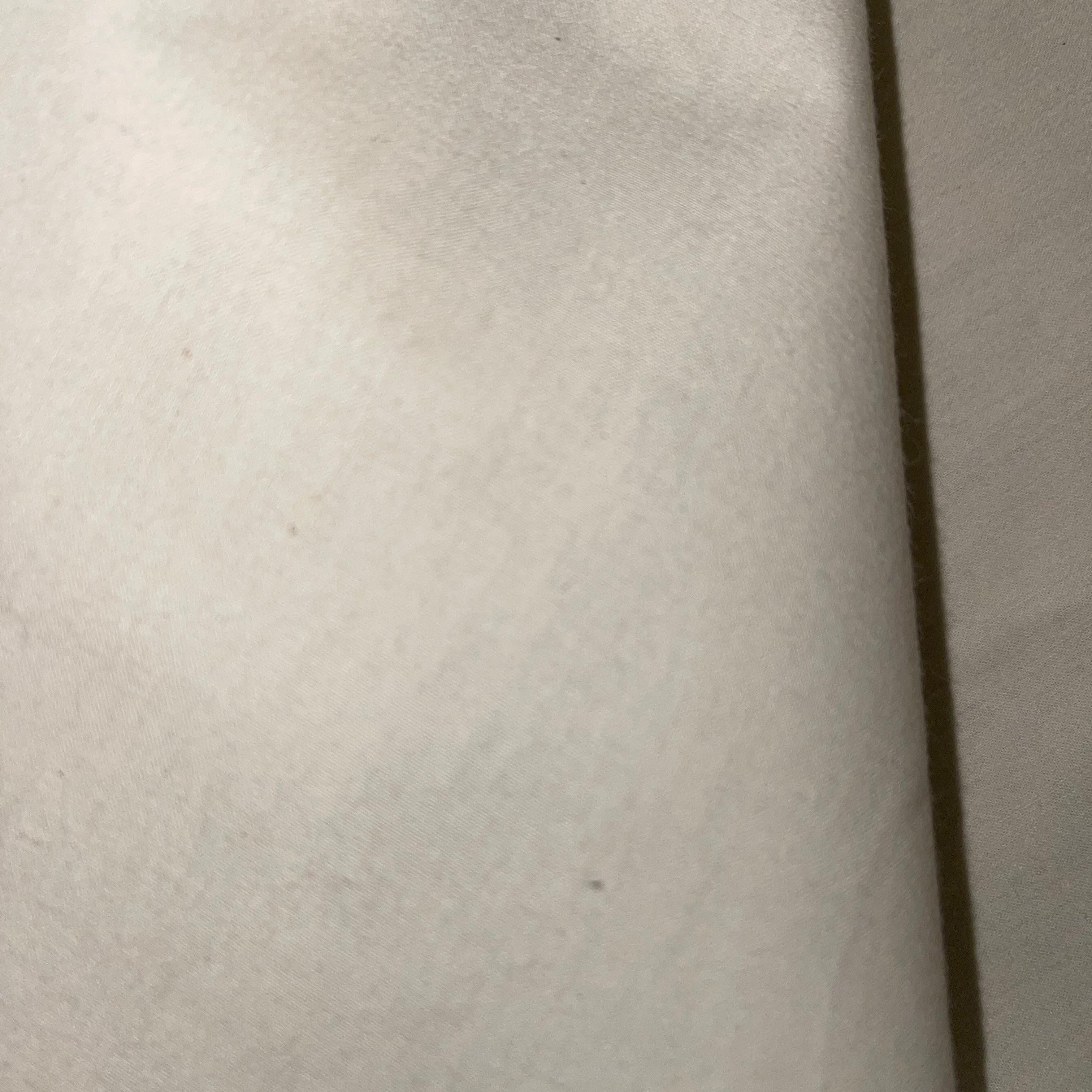 Close-up view of a beige cotton calico fabric.