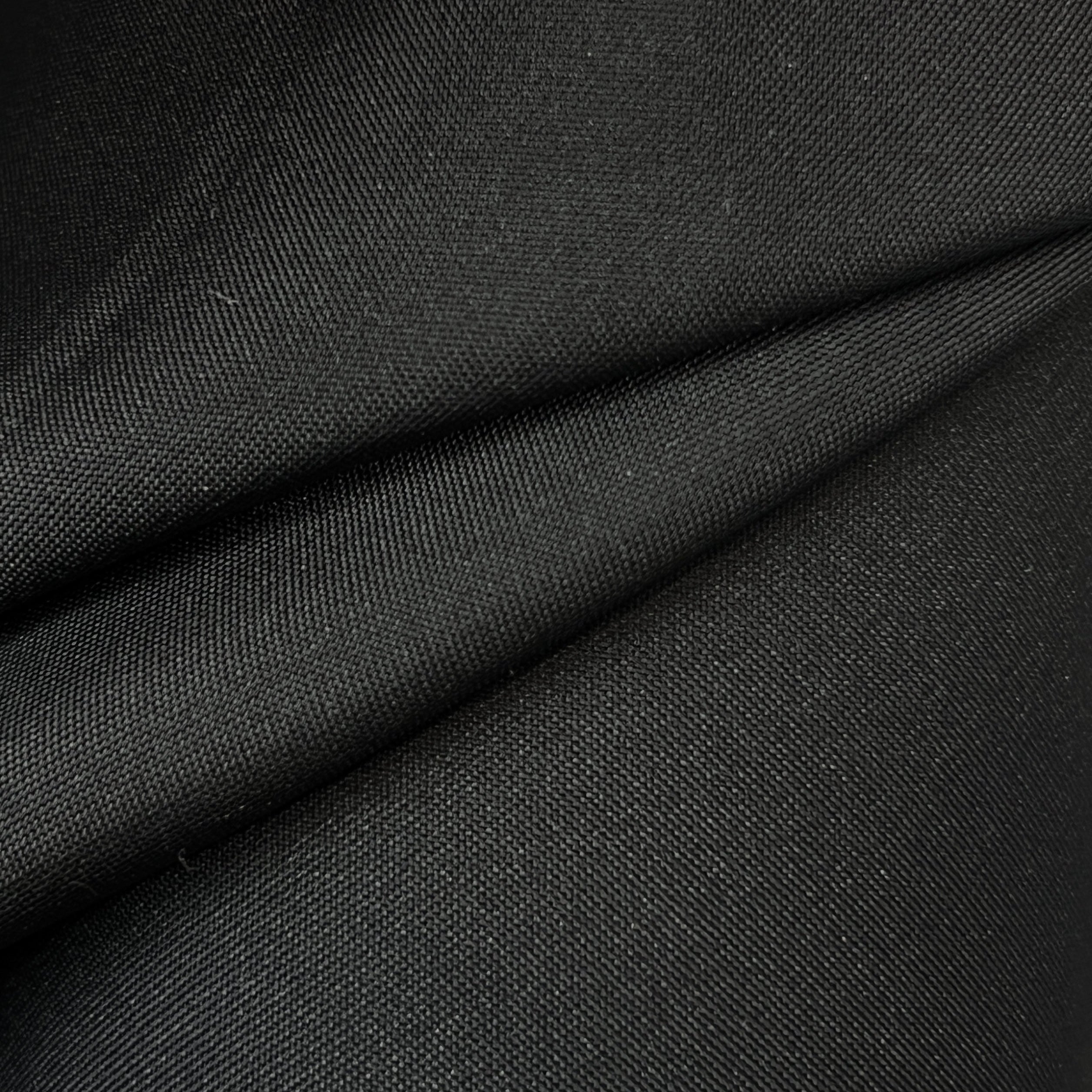 Close-up of dark gray fabric with a slight texture.