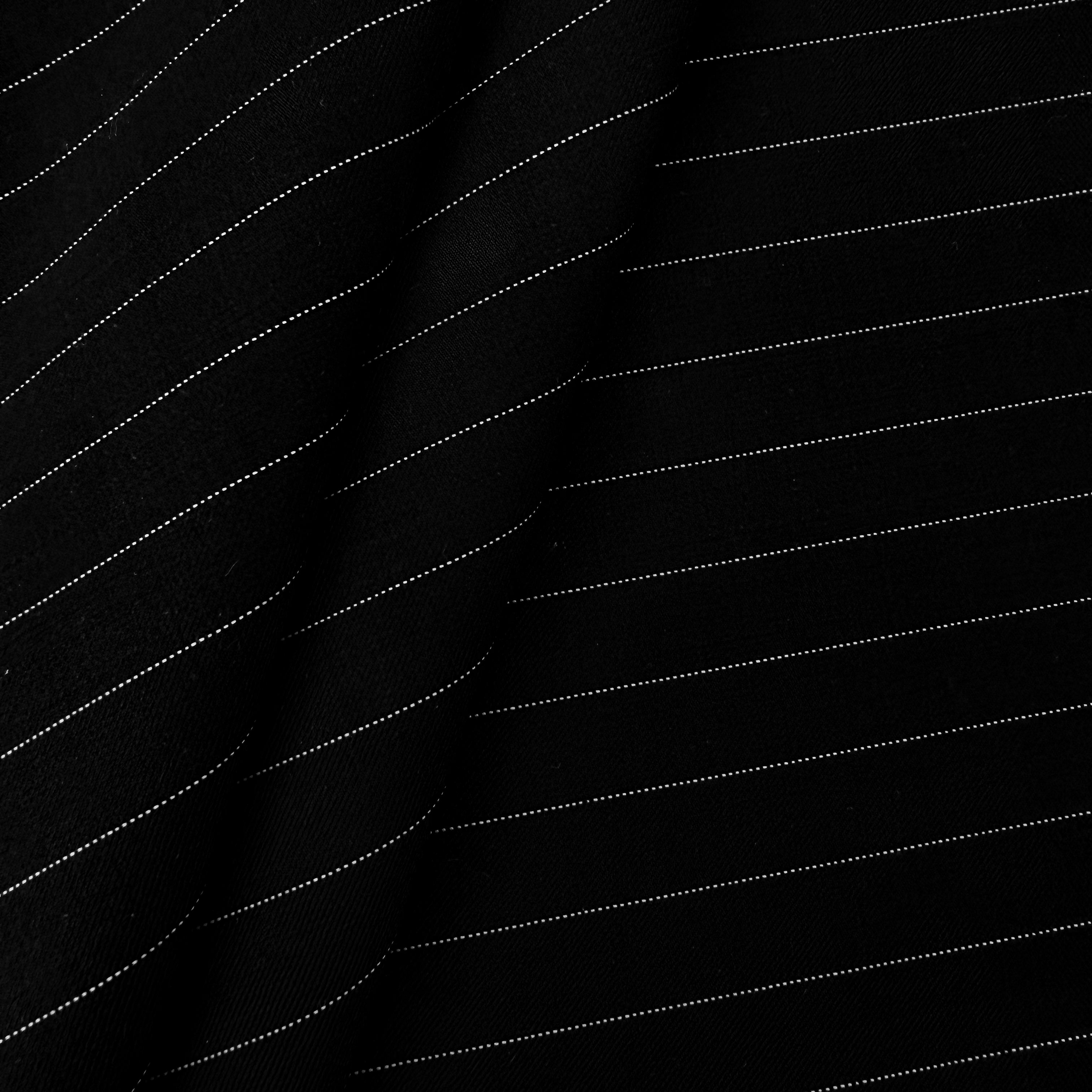 Black fabric with thin white pinstripes, shown in soft folds highlighting the texture and pattern.