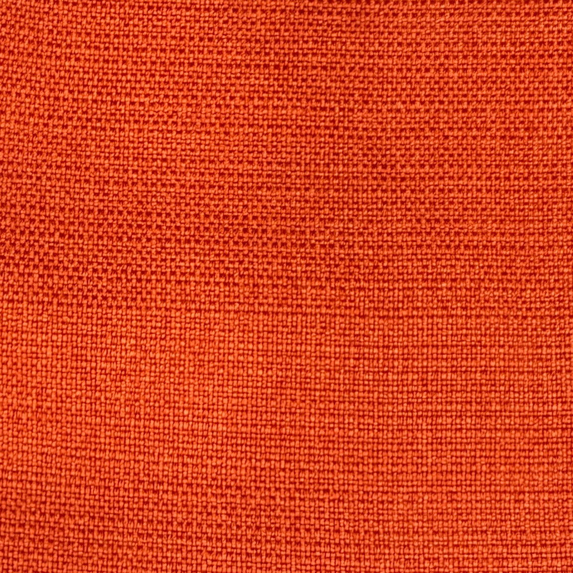 A close-up texture shot of a woven fabric in a vibrant orange color.