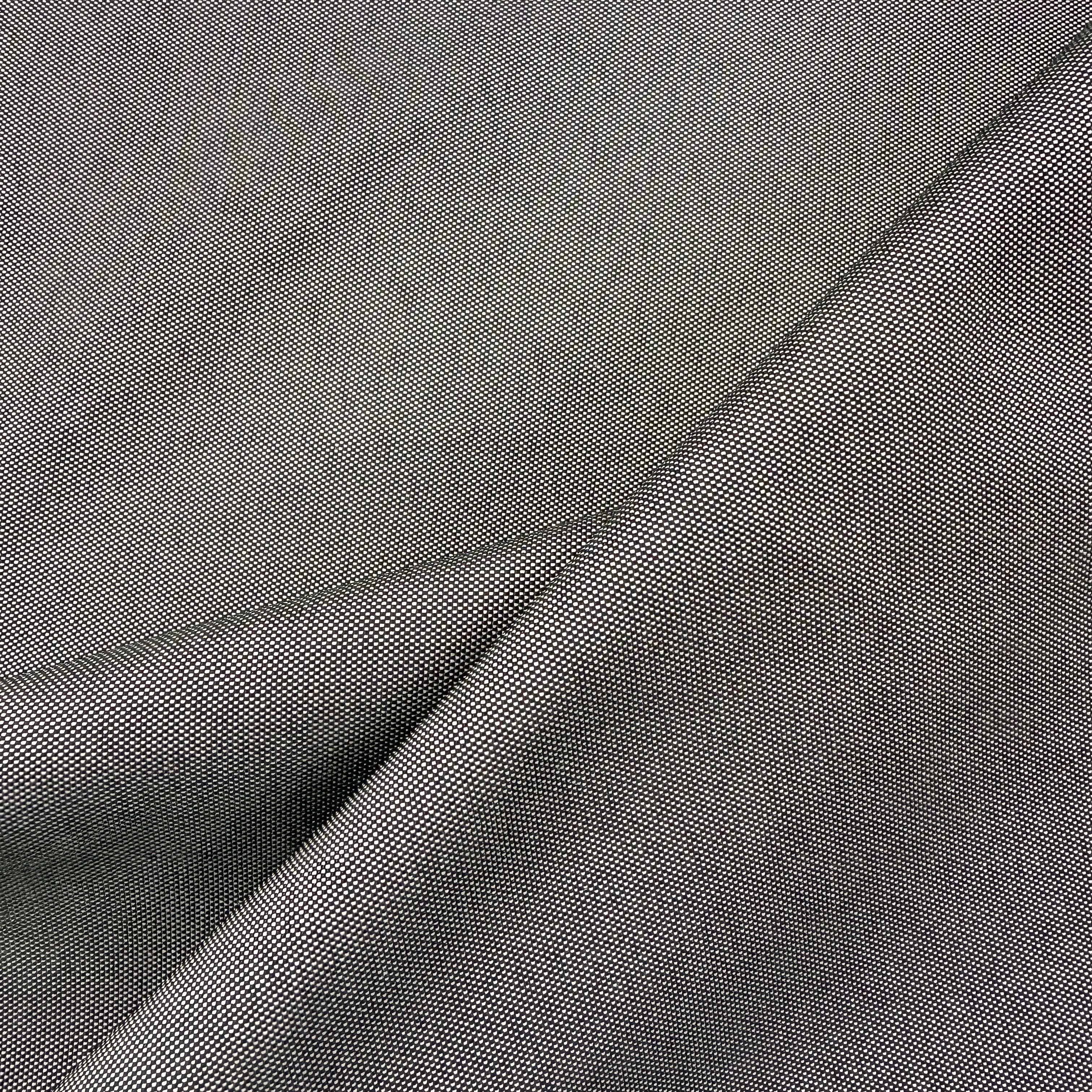 A close-up of dark gray fabric with a fine woven texture, shown in soft diagonal folds.