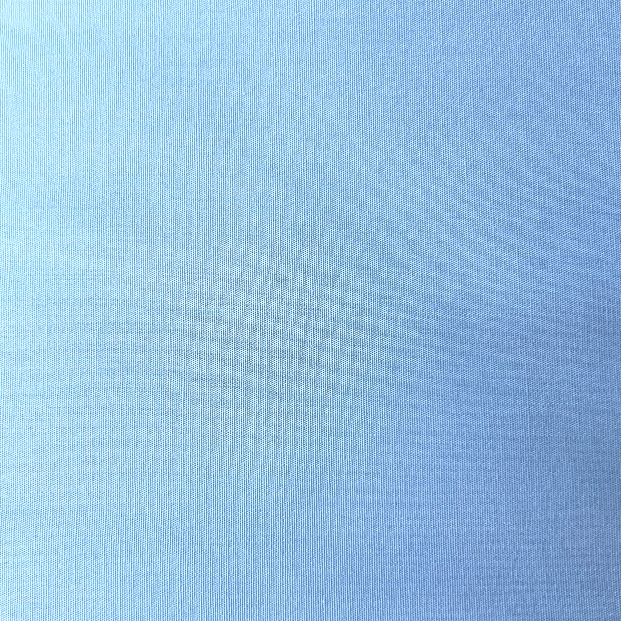 Sky blue 100% cotton poplin fabric with a plain weave texture.