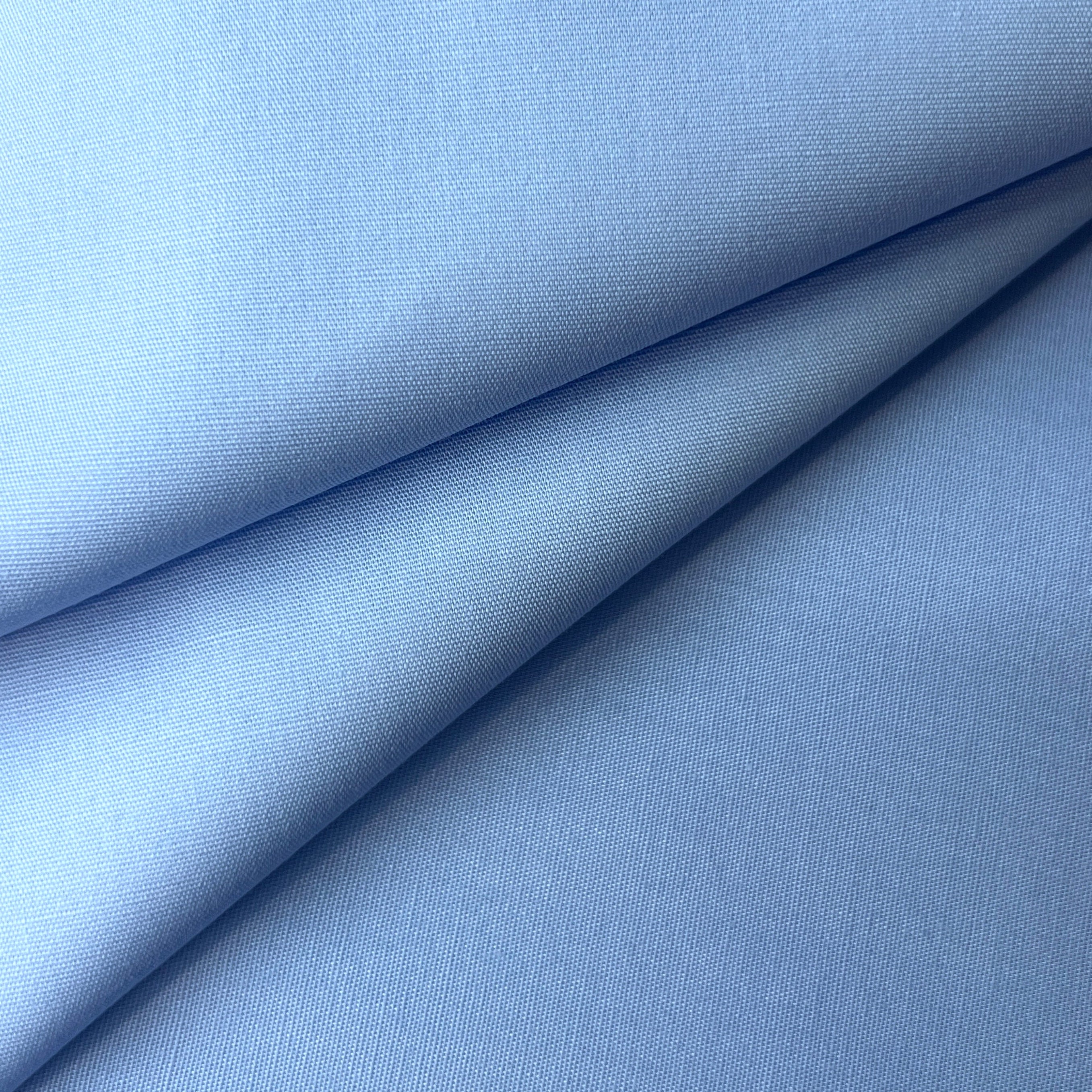Sky blue 100% cotton poplin fabric with a plain weave texture.