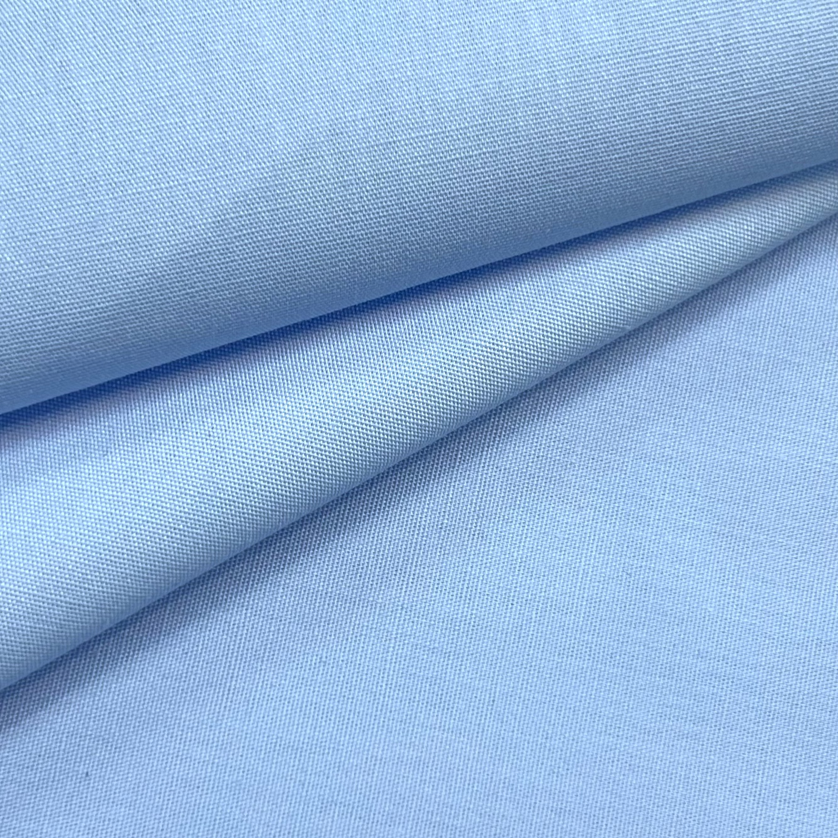 Light blue 100% cotton poplin fabric with a smooth, crisp texture.