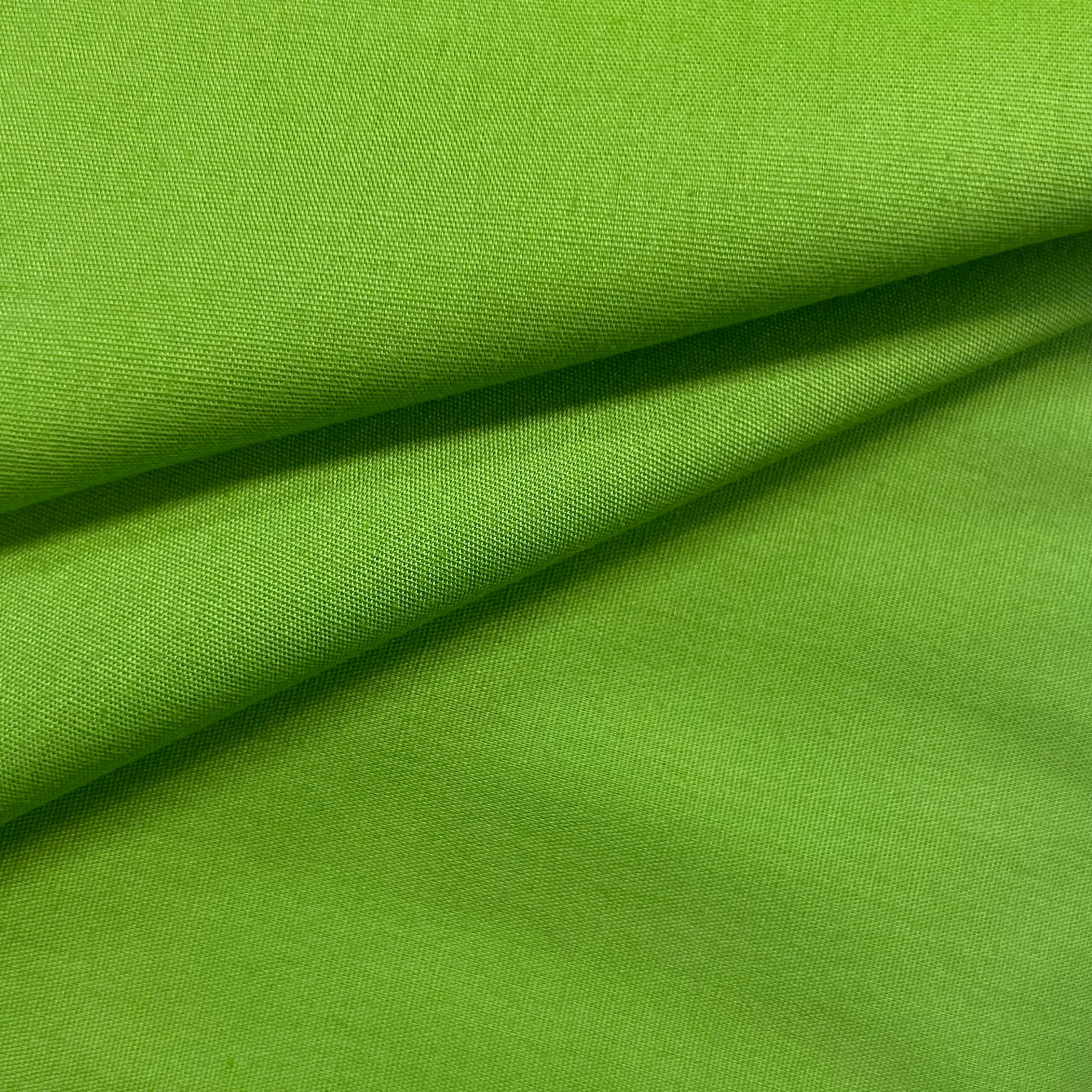 A swatch of bright green cotton poplin fabric with a visible weave texture.