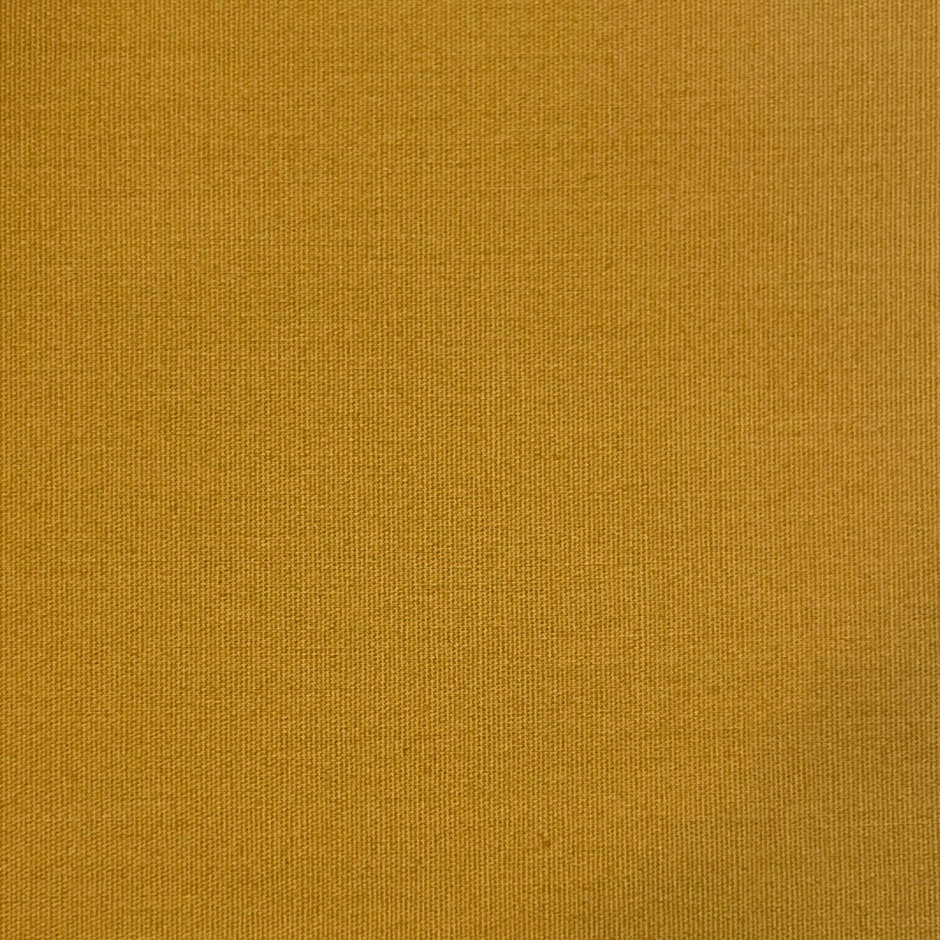 A textured mustard yellow cotton fabric.
