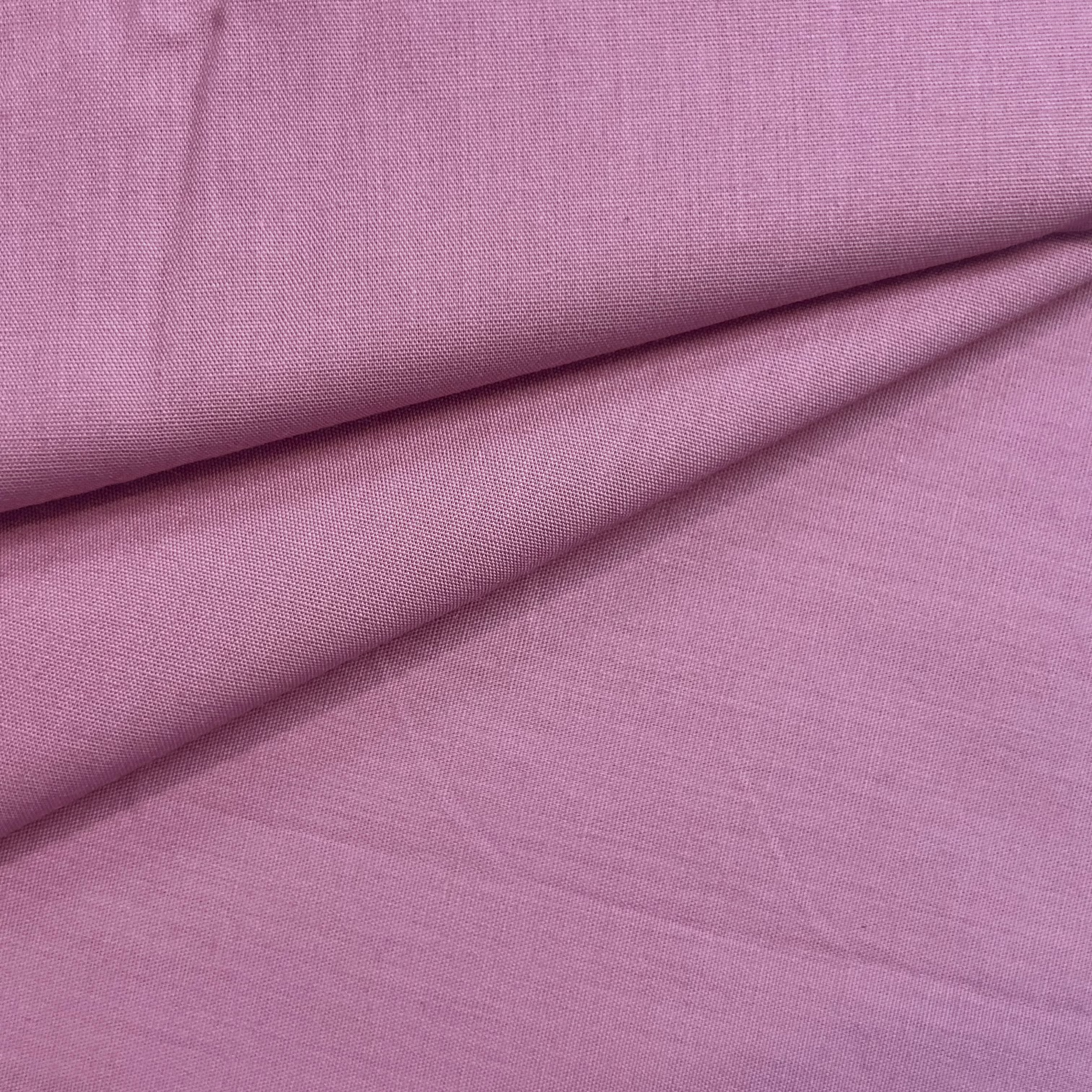 Cotton poplin fabric in a solid color with a smooth, crisp texture.