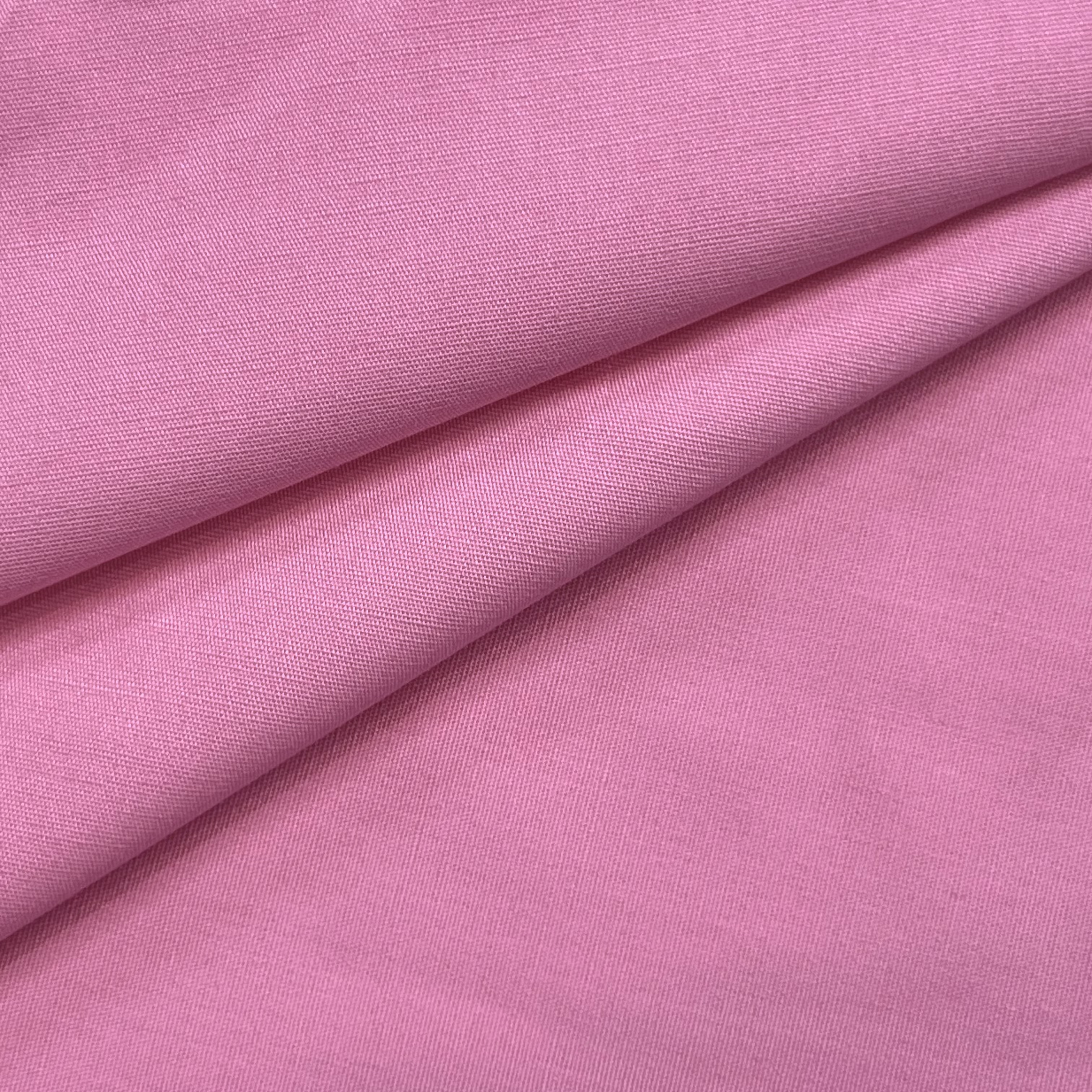 Pink cotton poplin fabric with a visible weave texture.