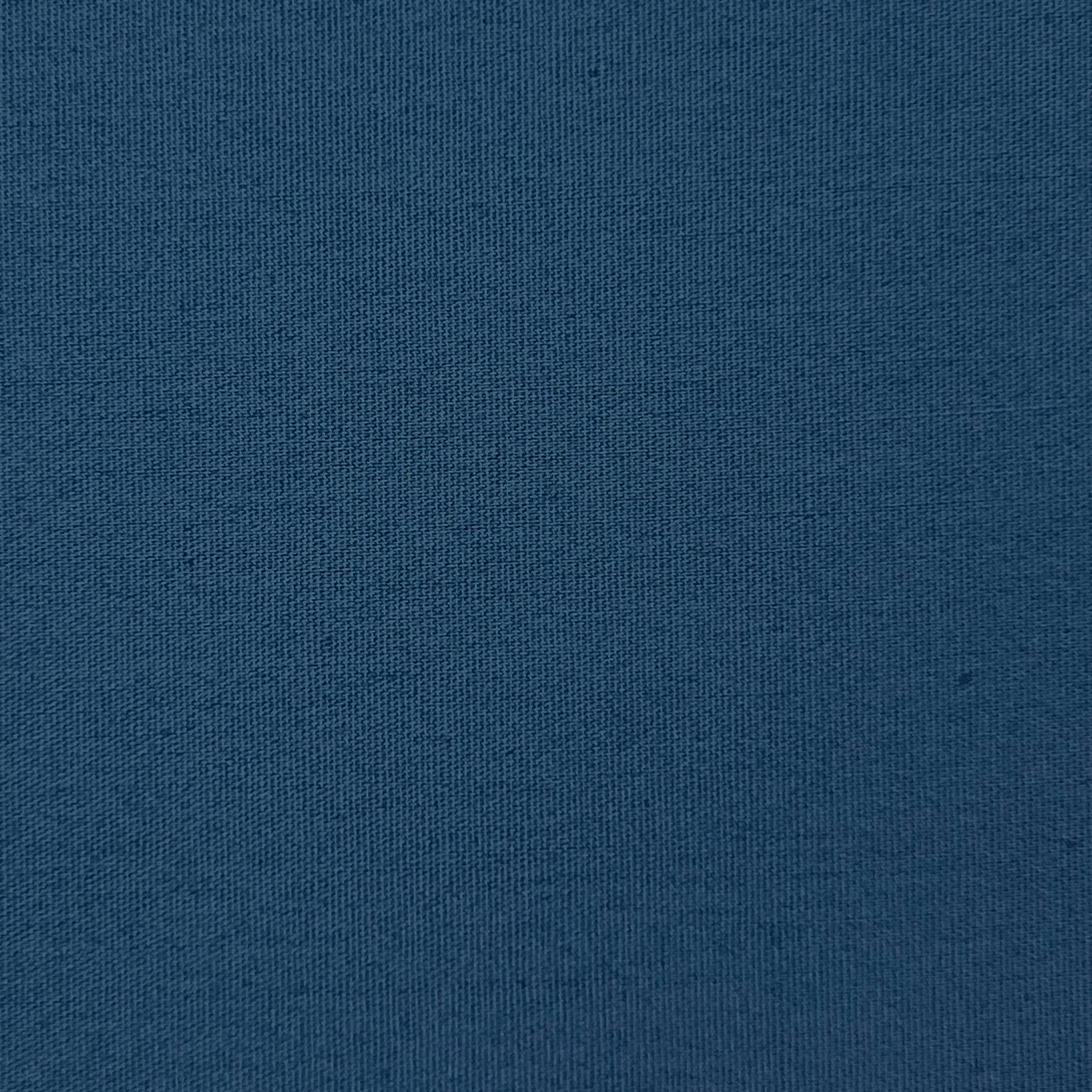 Close-up of a solid navy blue cotton poplin fabric with a fine, smooth weave.