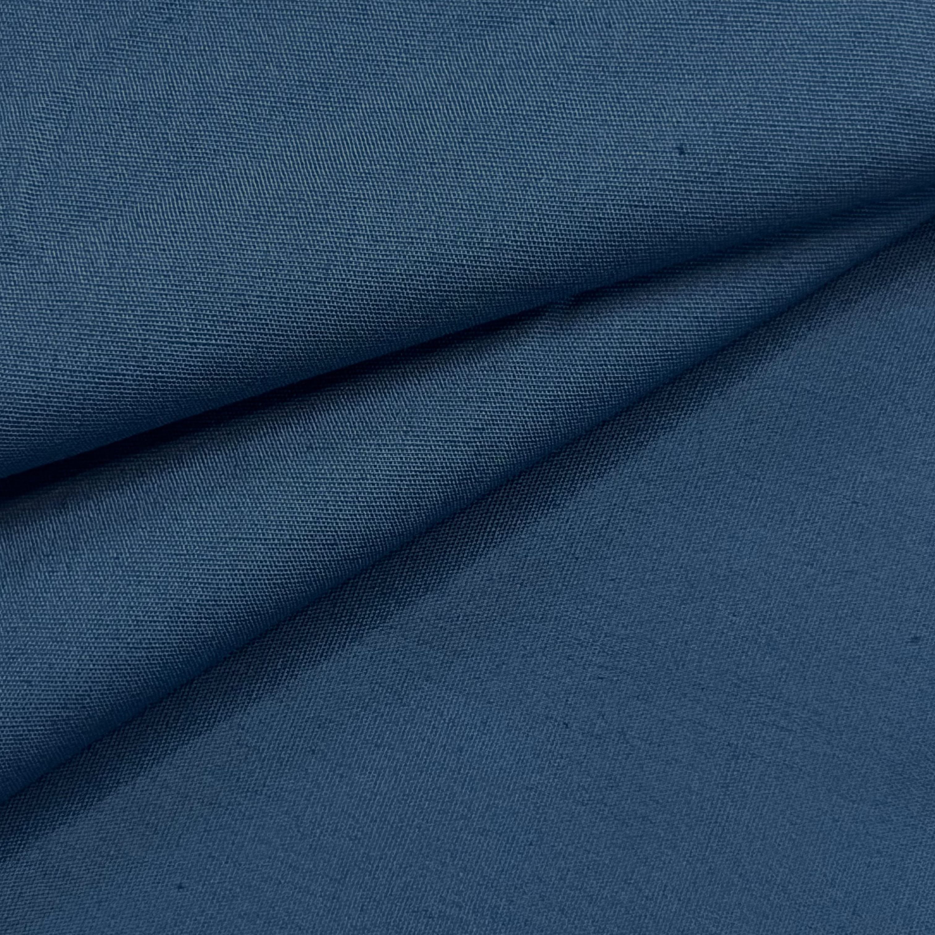 Close-up of navy blue cotton poplin fabric with a smooth, crisp texture and subtle sheen.