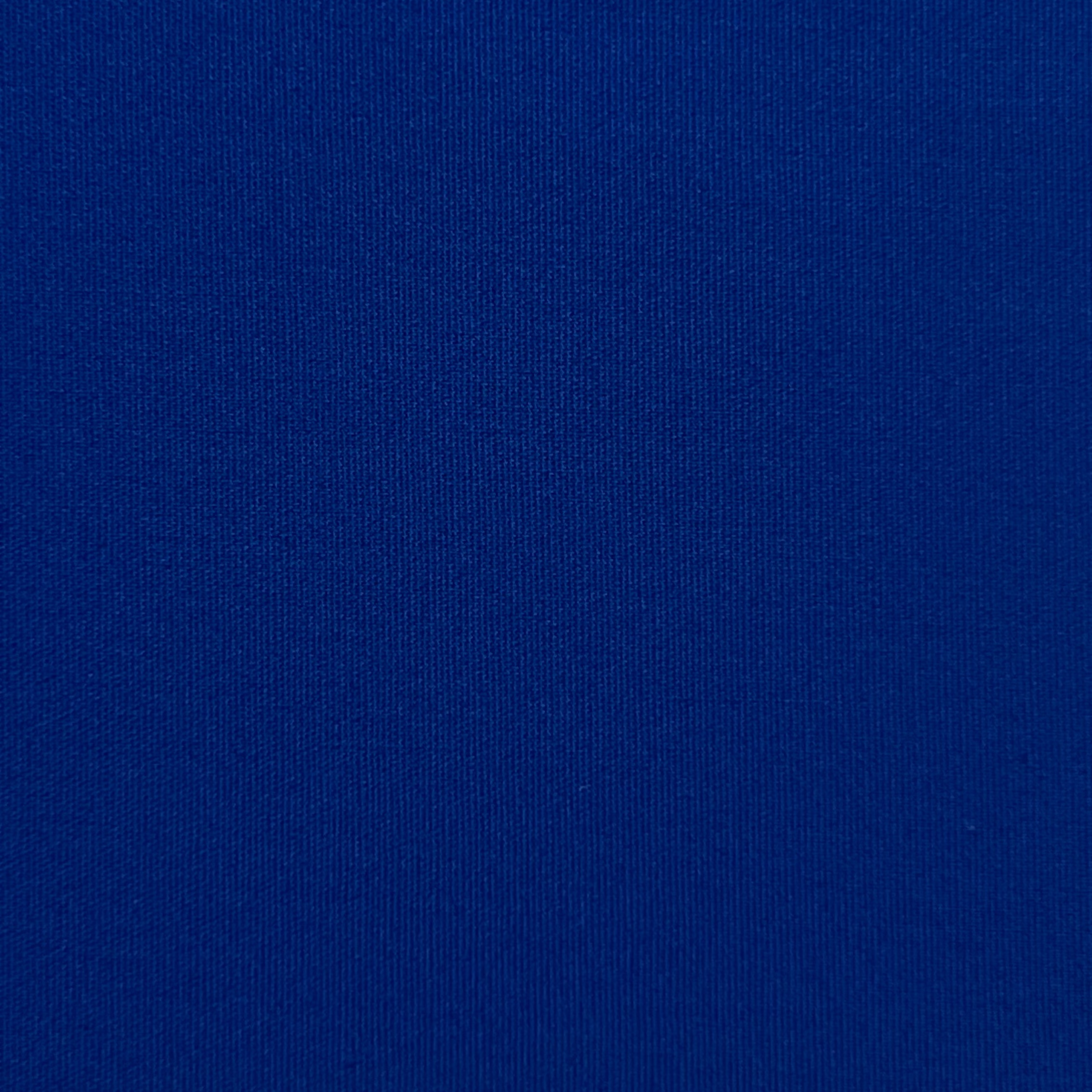 A close-up view of royal blue cotton poplin fabric showing its fine, smooth weave.