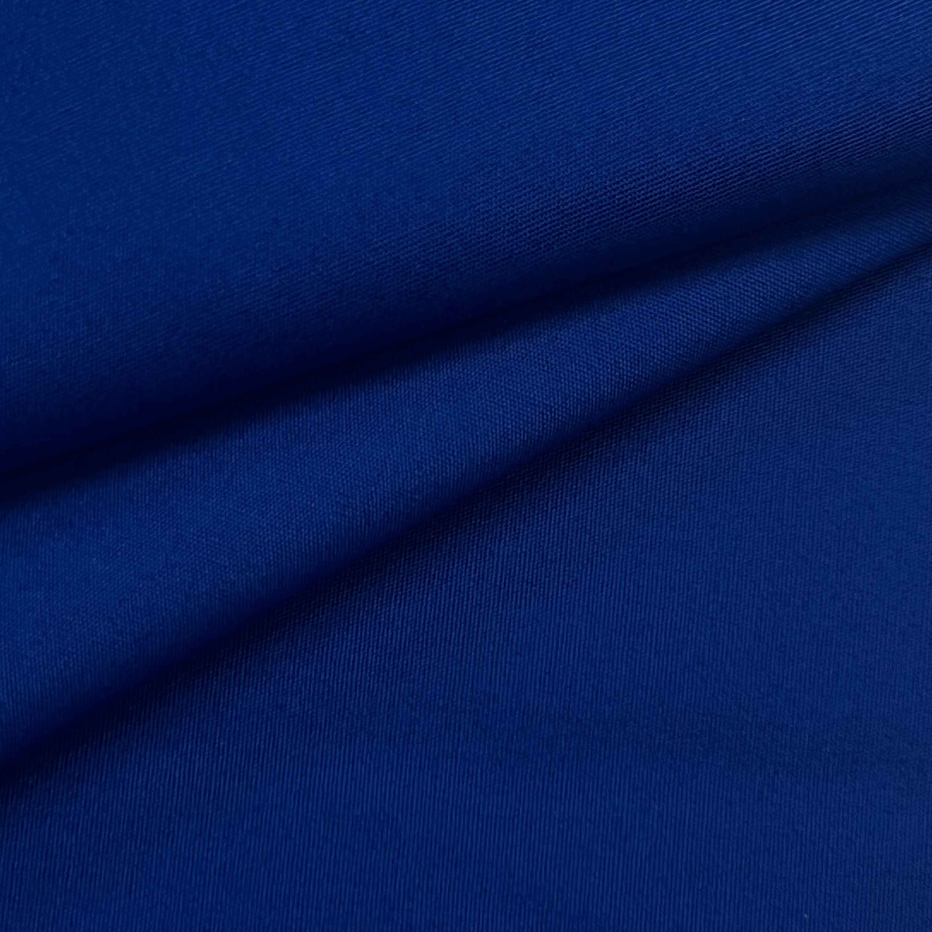 A close-up of royal blue cotton poplin fabric with a smooth, crisp texture and subtle sheen.