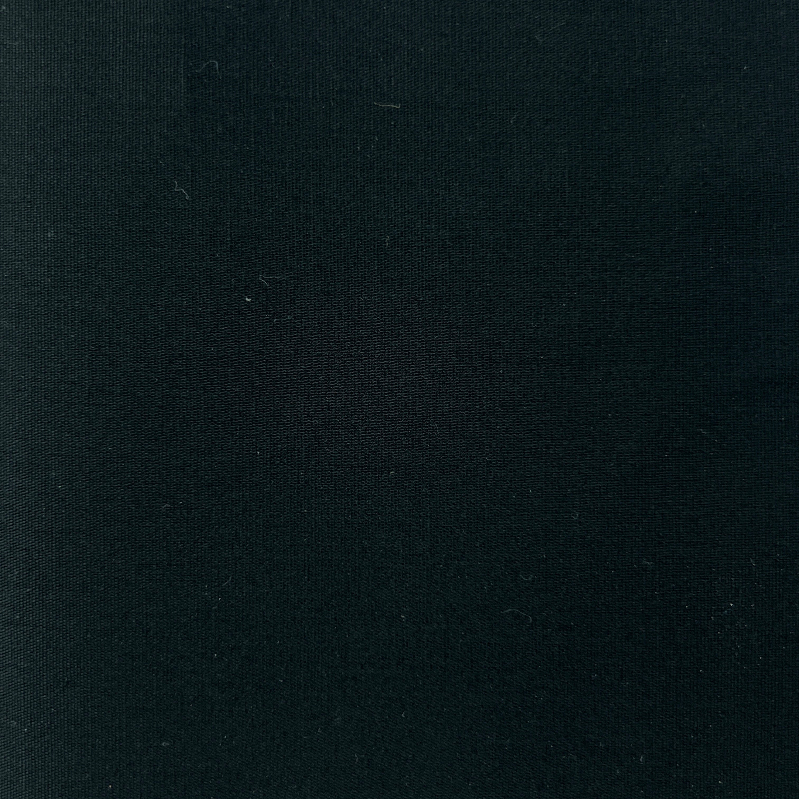 A close-up of a solid black textured fabric surface.