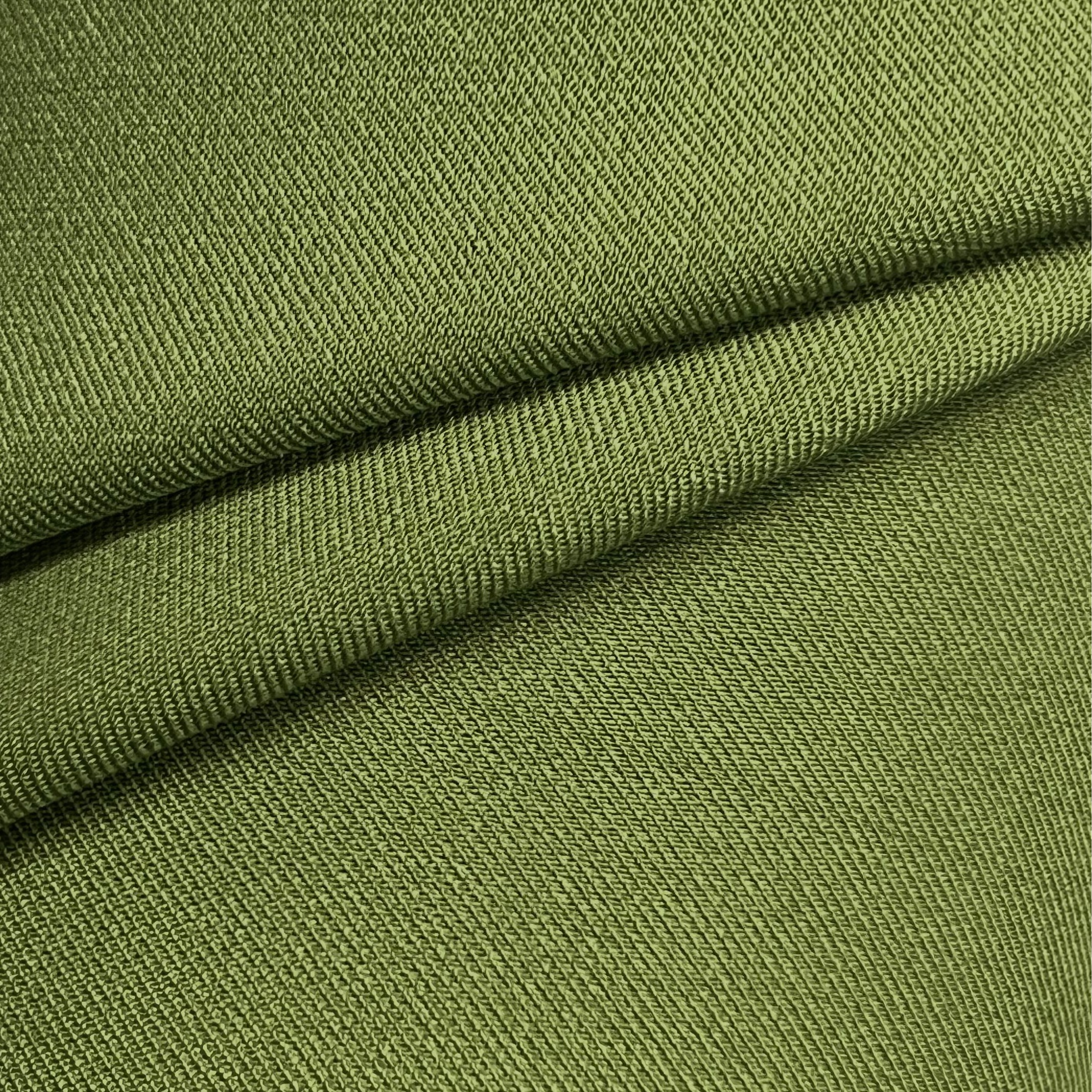 Close-up of olive green virgin wool and silk tweed fabric with a textured, diagonal weave.
