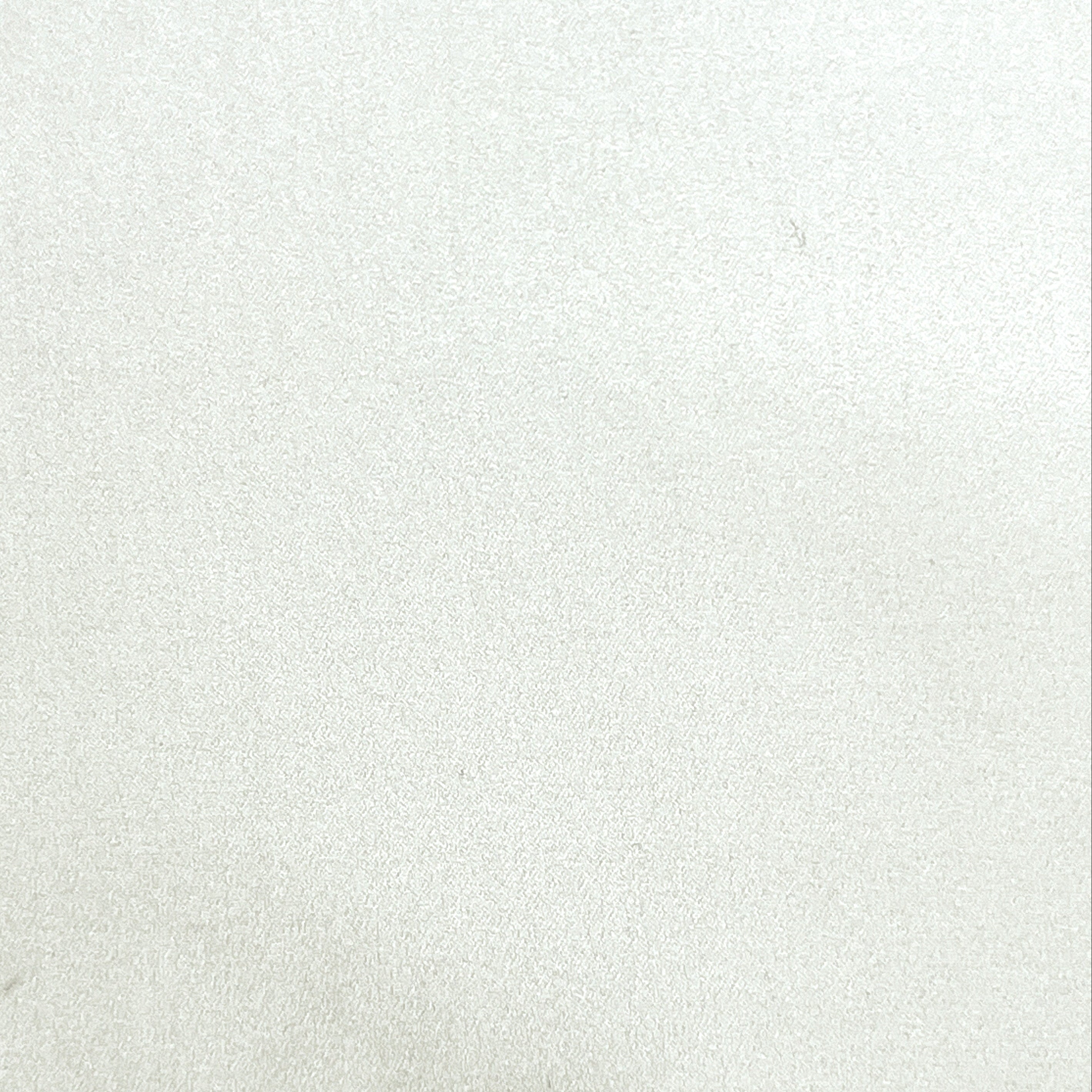 A close-up of a light off-white or cream textured surface, likely a fabric swatch or material sample.