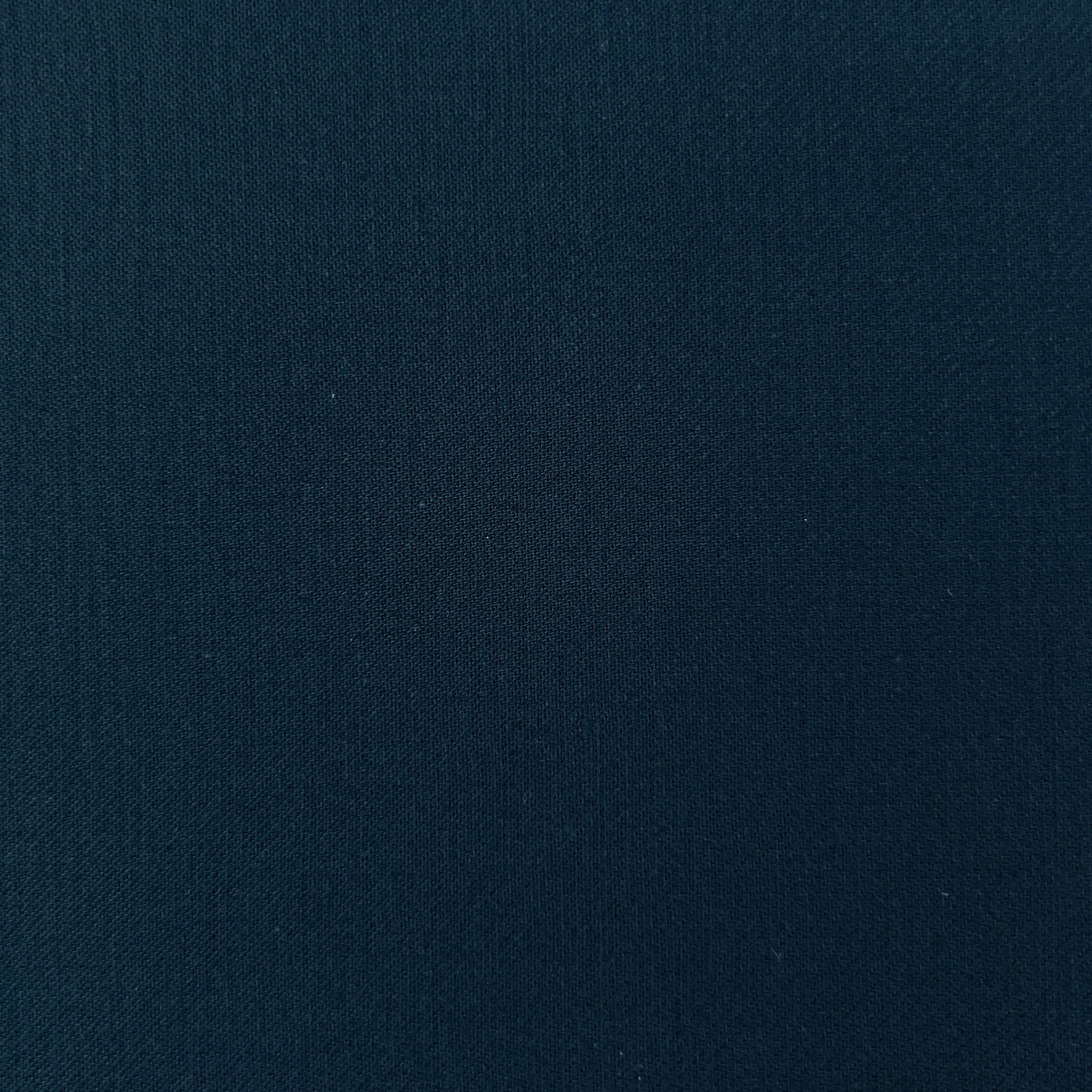 A close-up of dark navy blue textured fabric filling the frame.