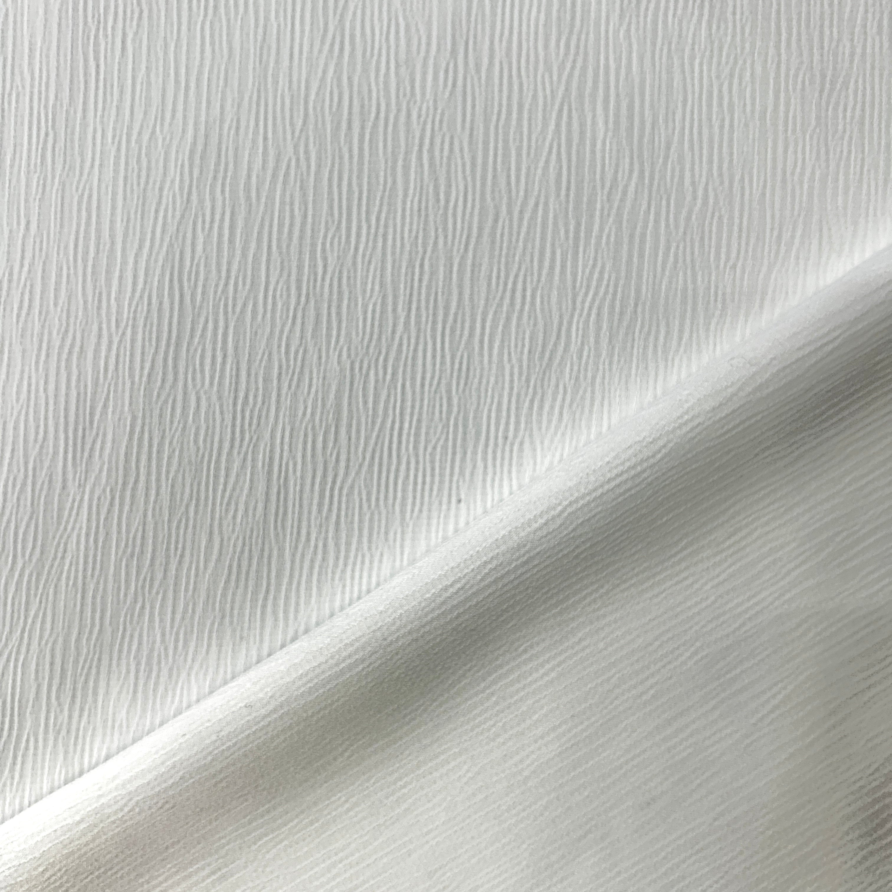 Close-up of white fabric with a subtle texture