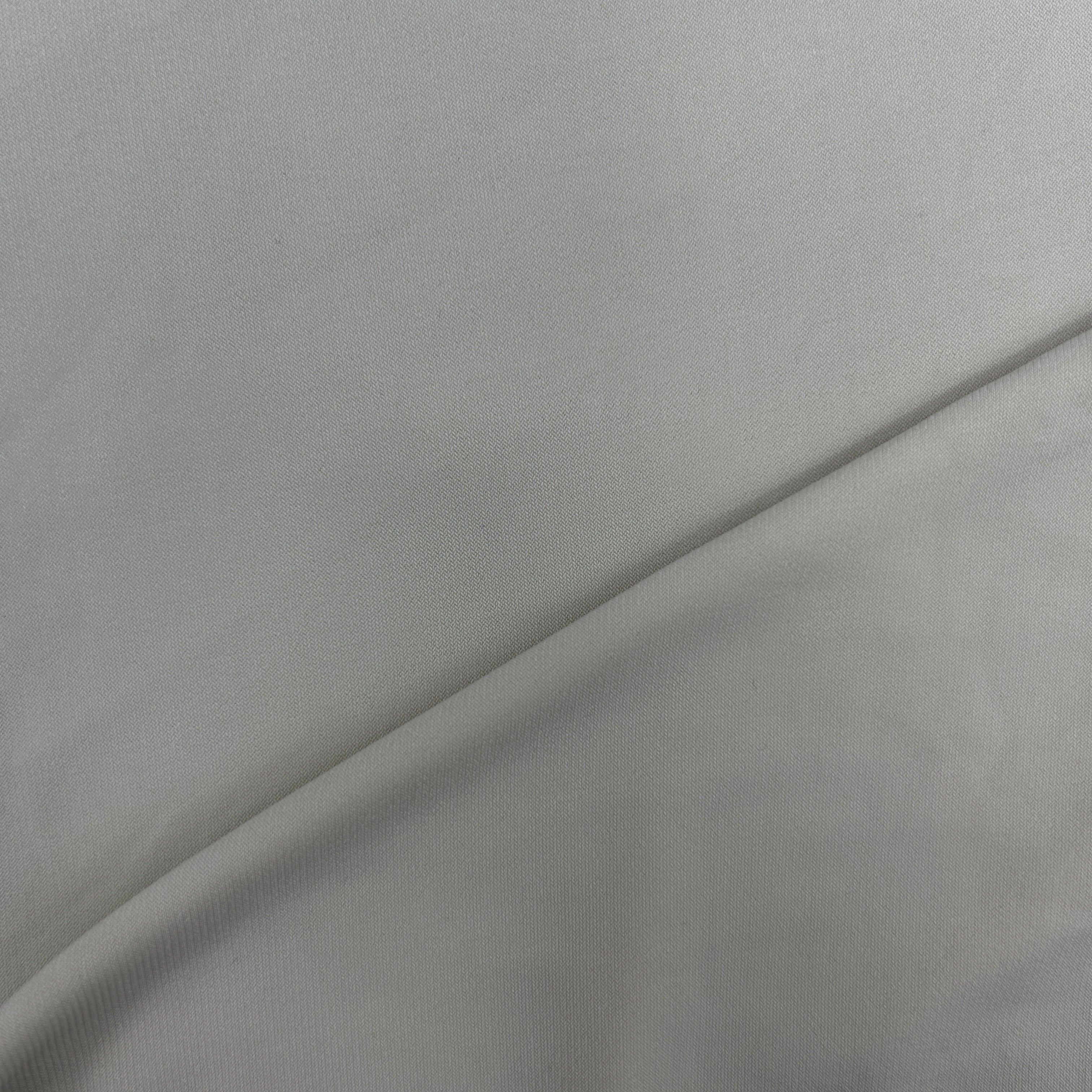 A close-up of light gray fabric with a soft diagonal fold.