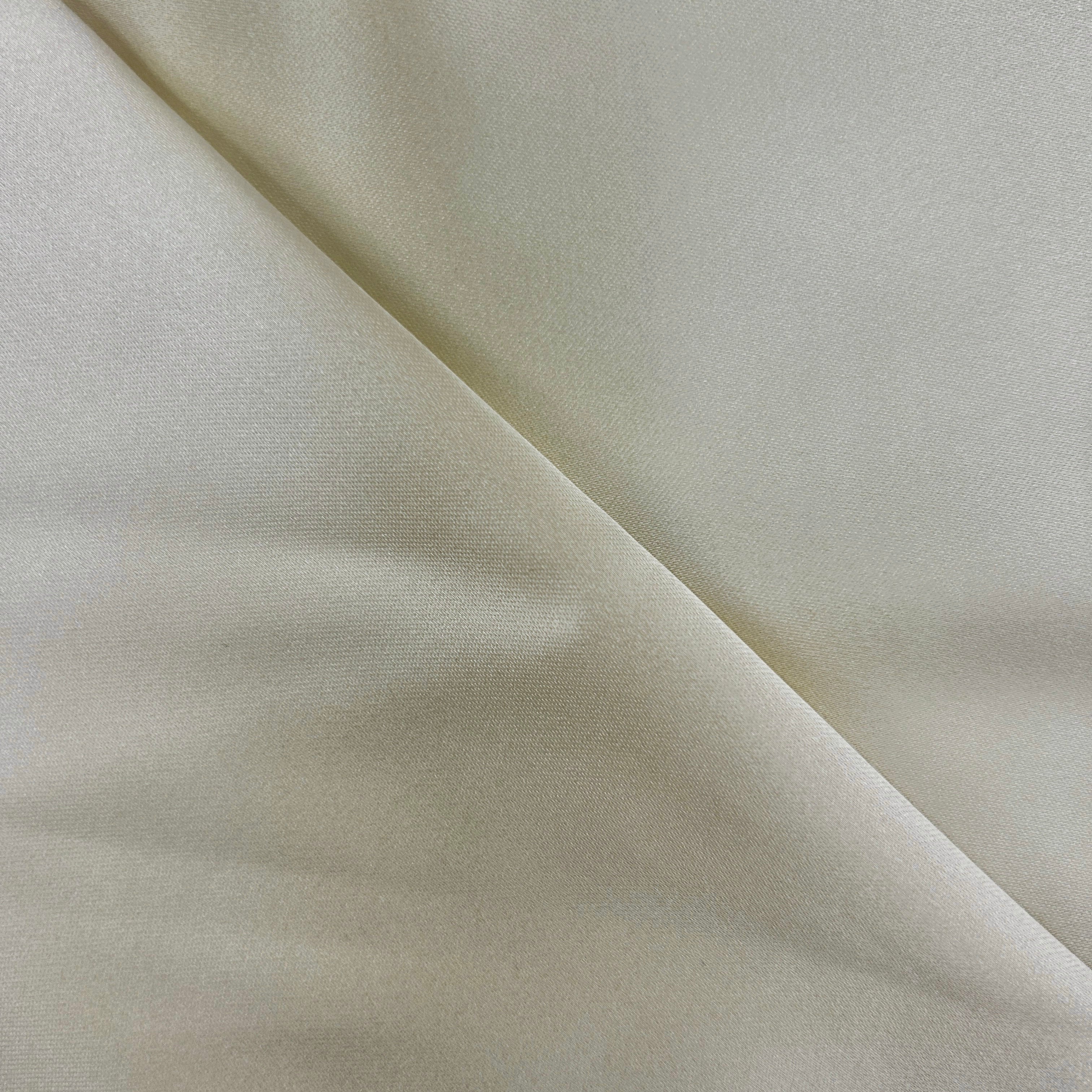 A close-up of draped off-white fabric with soft folds and a subtle sheen.