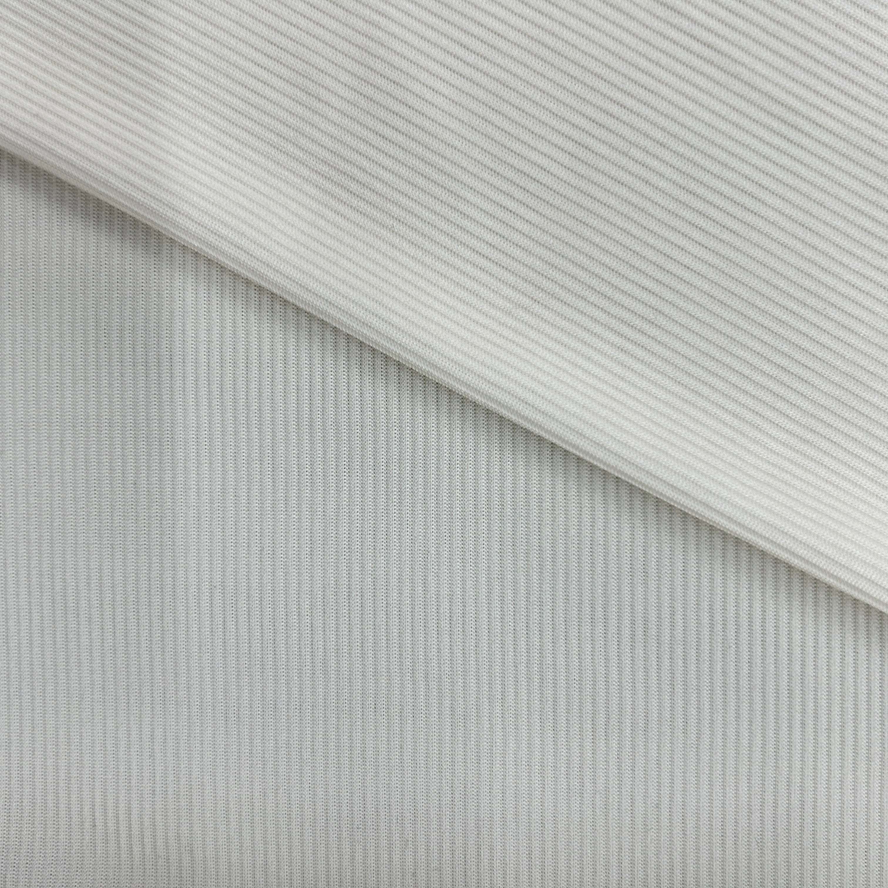 A close-up of a light gray ribbed fabric, showing a diagonal fold that highlights the fine vertical ribbed texture.