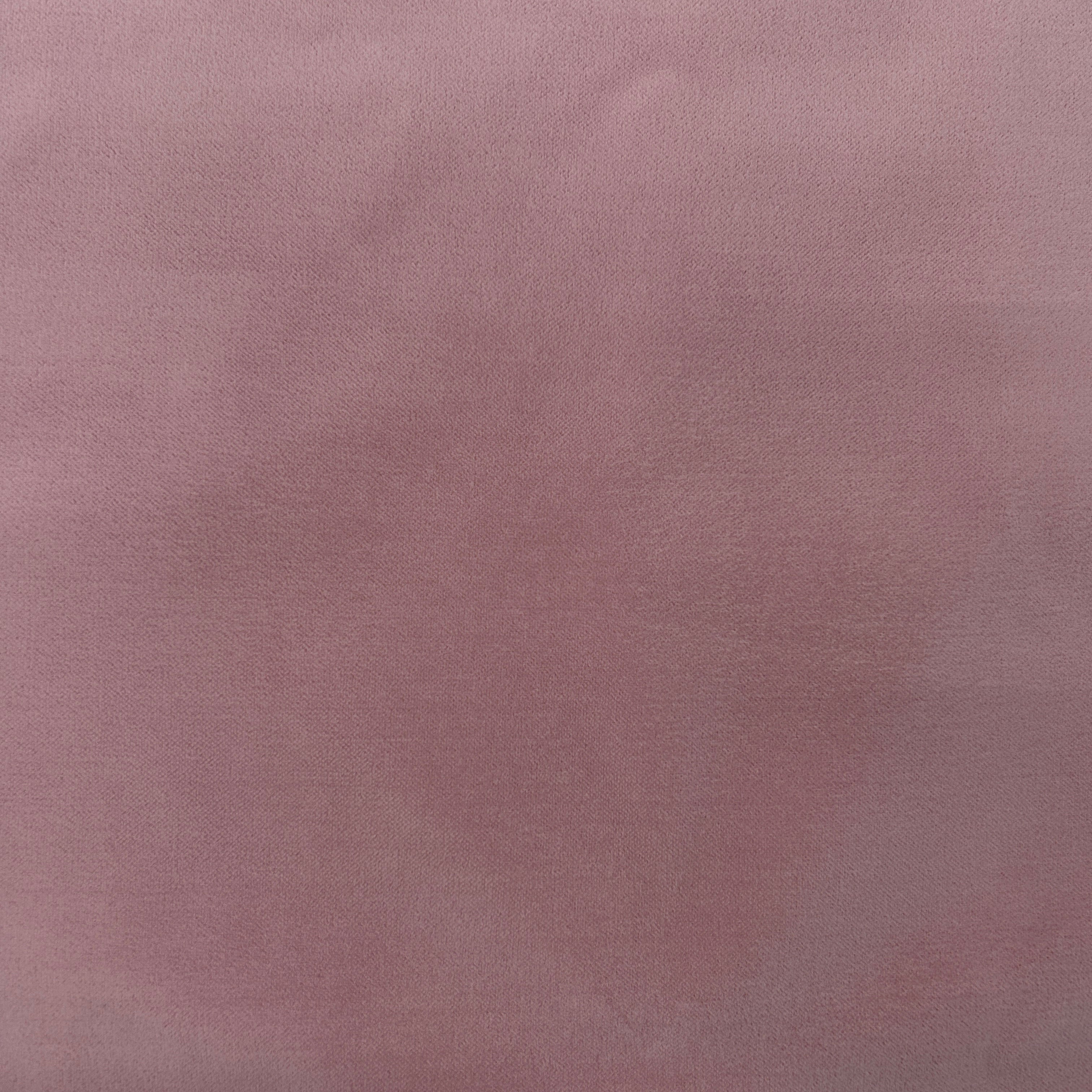 A close-up of a dusty mauve or muted pink textured material surface filling the frame.