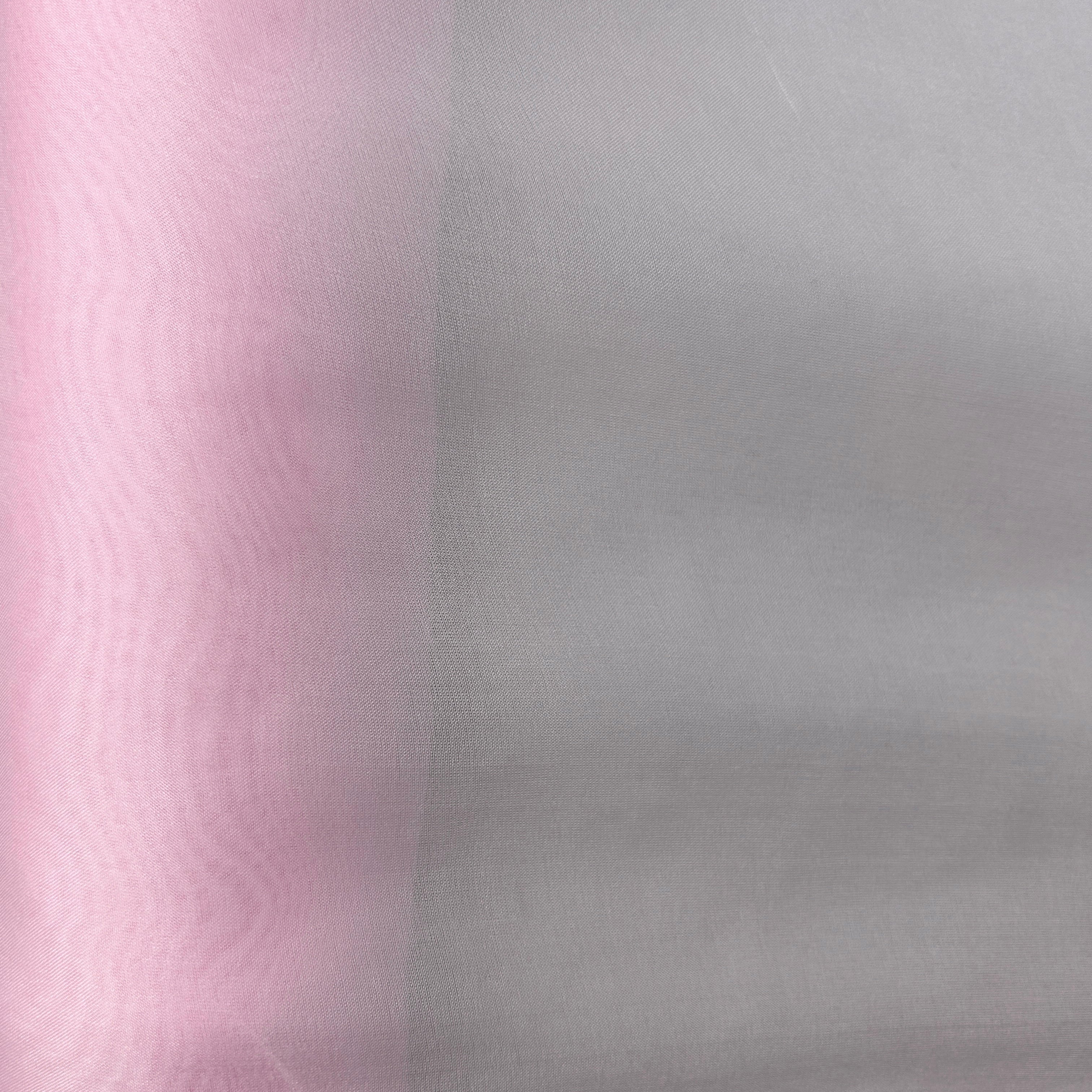 A close-up of sheer mesh fabric showing two color options: a light pink on the left and a light gray on the right, divided by a vertical seam.