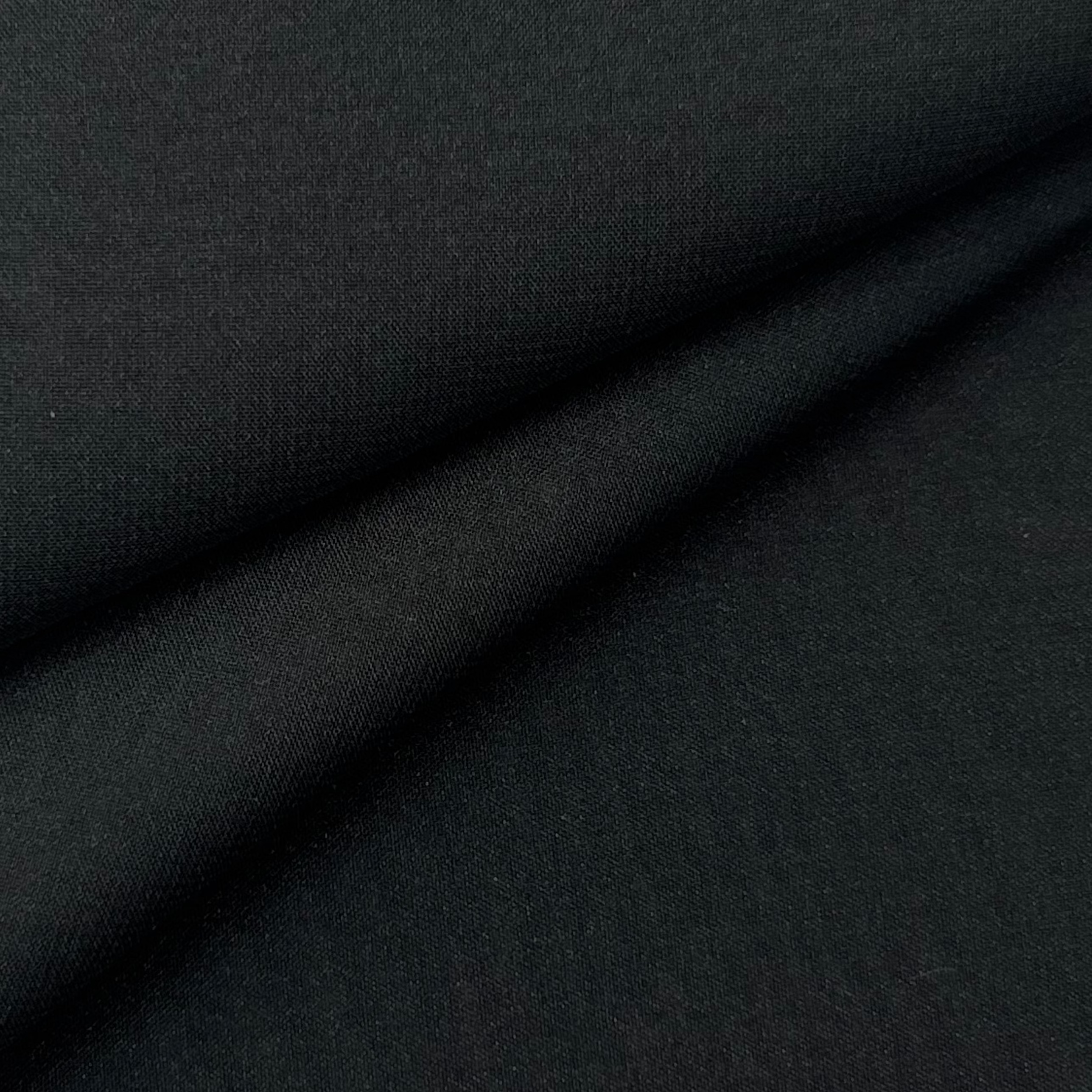 A folded piece of solid black ultra-thin polyester chiffon fabric with a matte finish.