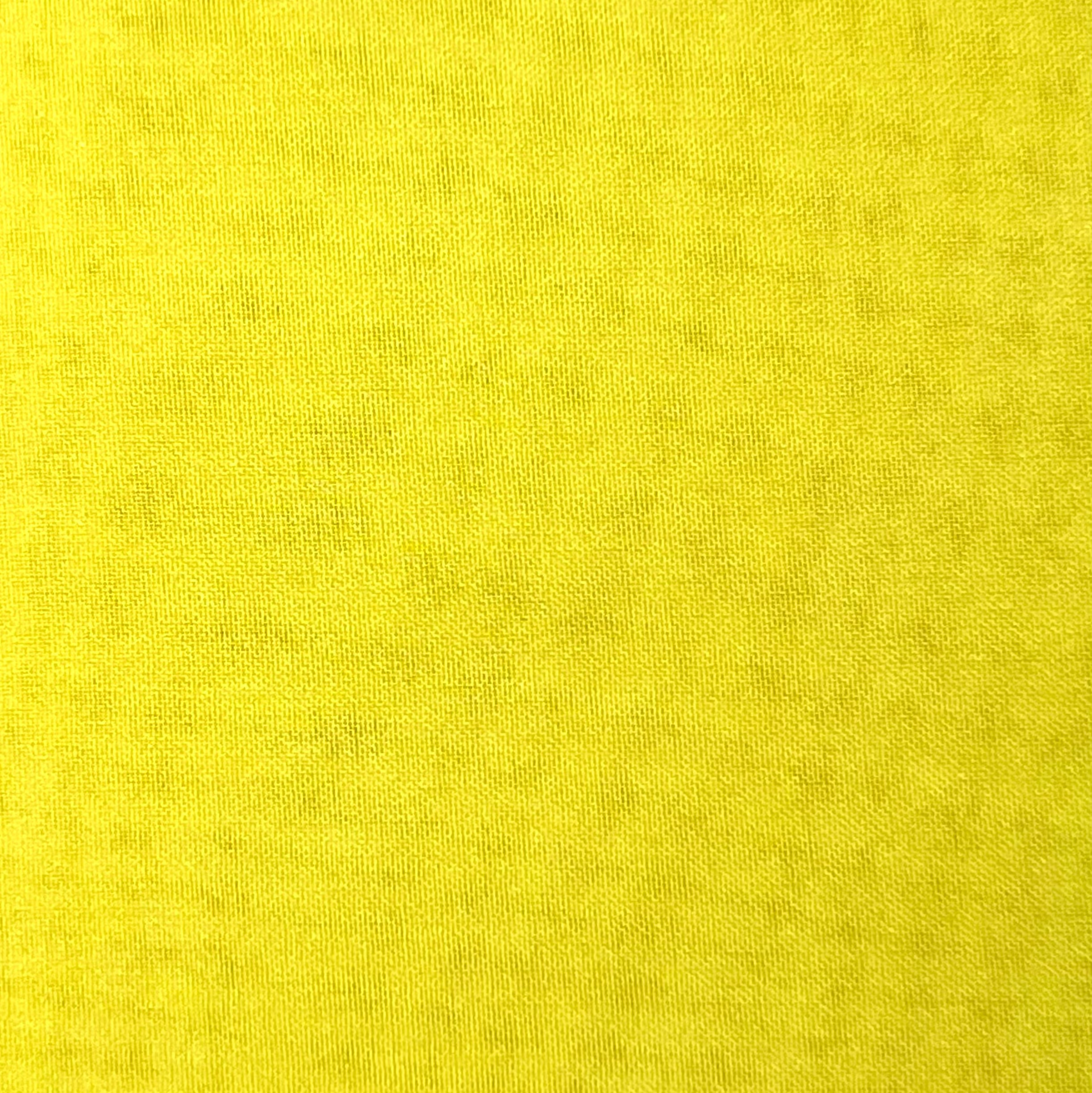A close-up view of high-quality, ultra-thin yellow polyester chiffon fabric with a fine weave.